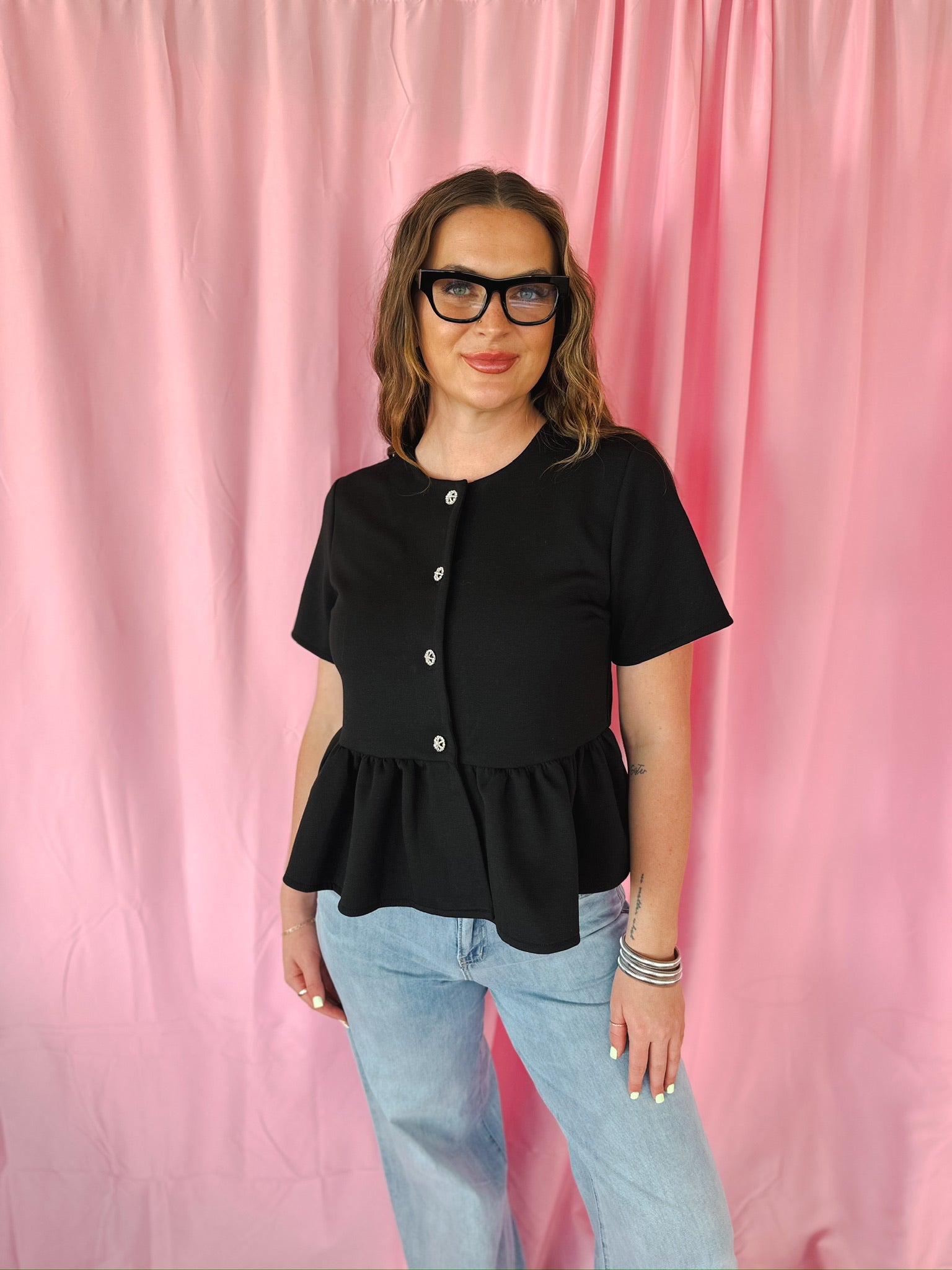 Entro black jeweled button peplum jacket with short sleeves and flared hem.