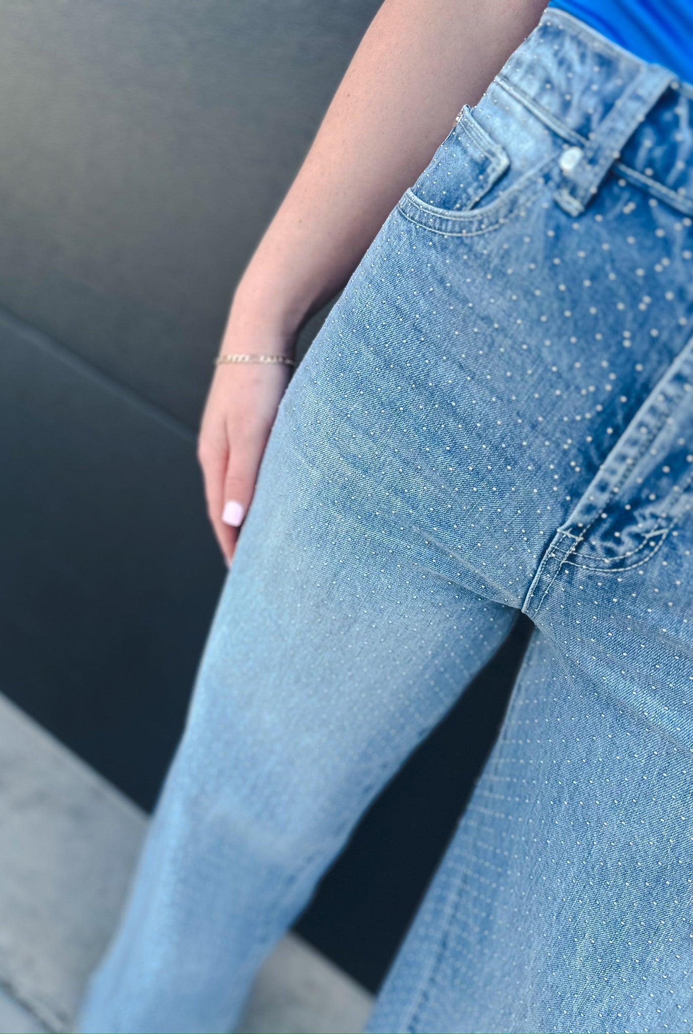 Light wash denim wide leg jeans with all-over micro stud embellishments. High-rise waist with front pockets and a slouch fit.