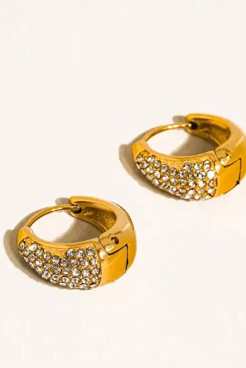 Aurven 18K gold teardrop hoop earrings adorned with sparkling crystals, showcasing a polished metal finish against a white