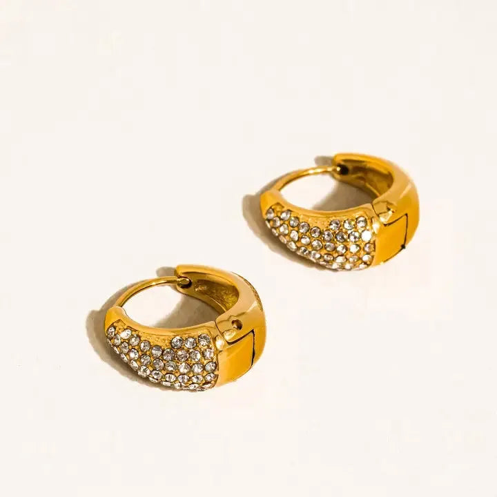 Aurven 18K gold teardrop hoop earrings adorned with sparkling crystals, showcasing a polished metal finish against a white