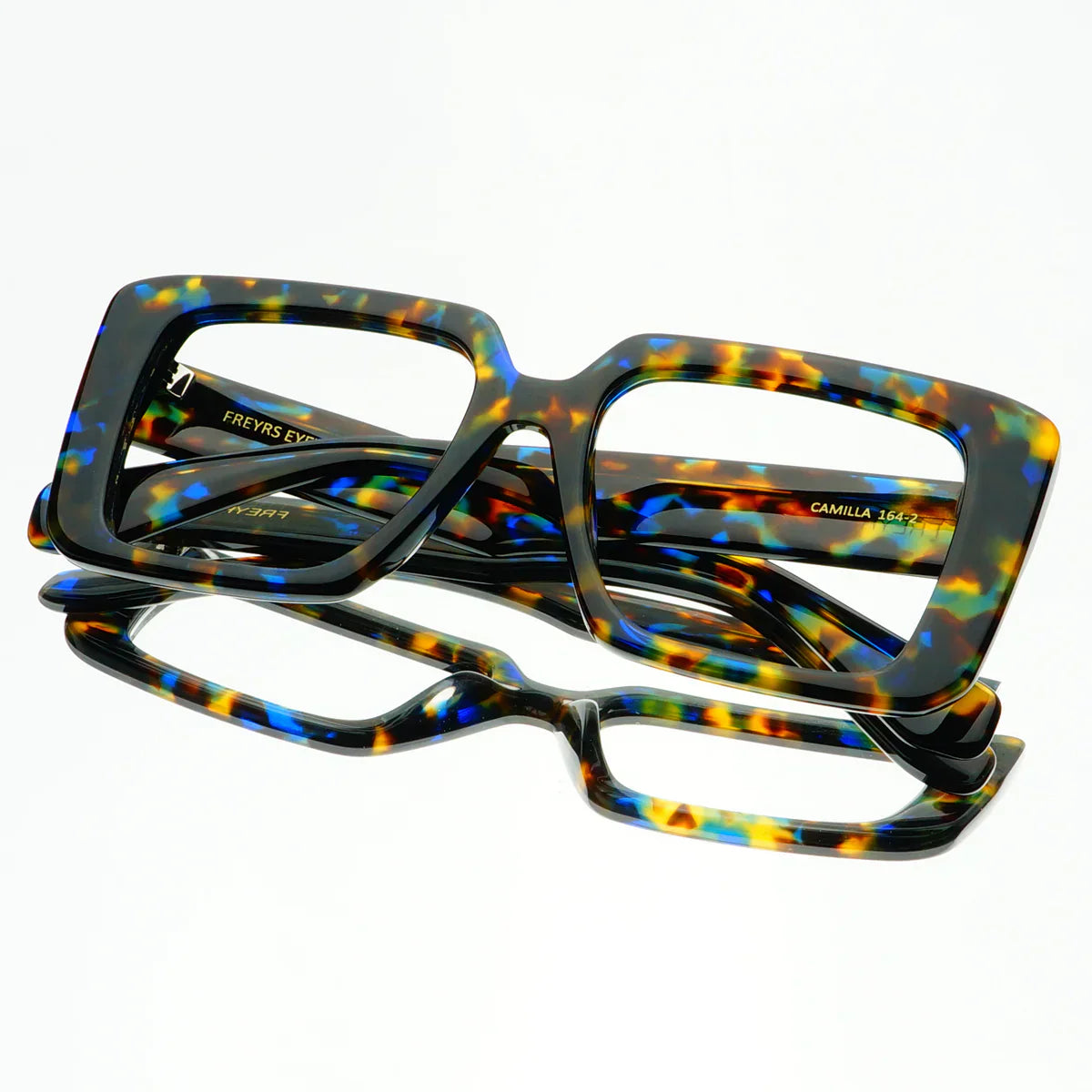 Camilla blue light reading glasses featuring a multi-colored tortoiseshell pattern on oversized square frames. Includes