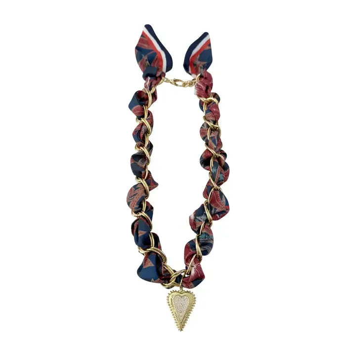 Carson Scarf Necklace: A gold chain necklace interwoven with navy, red, and white paisley-patterned fabric, featuring a