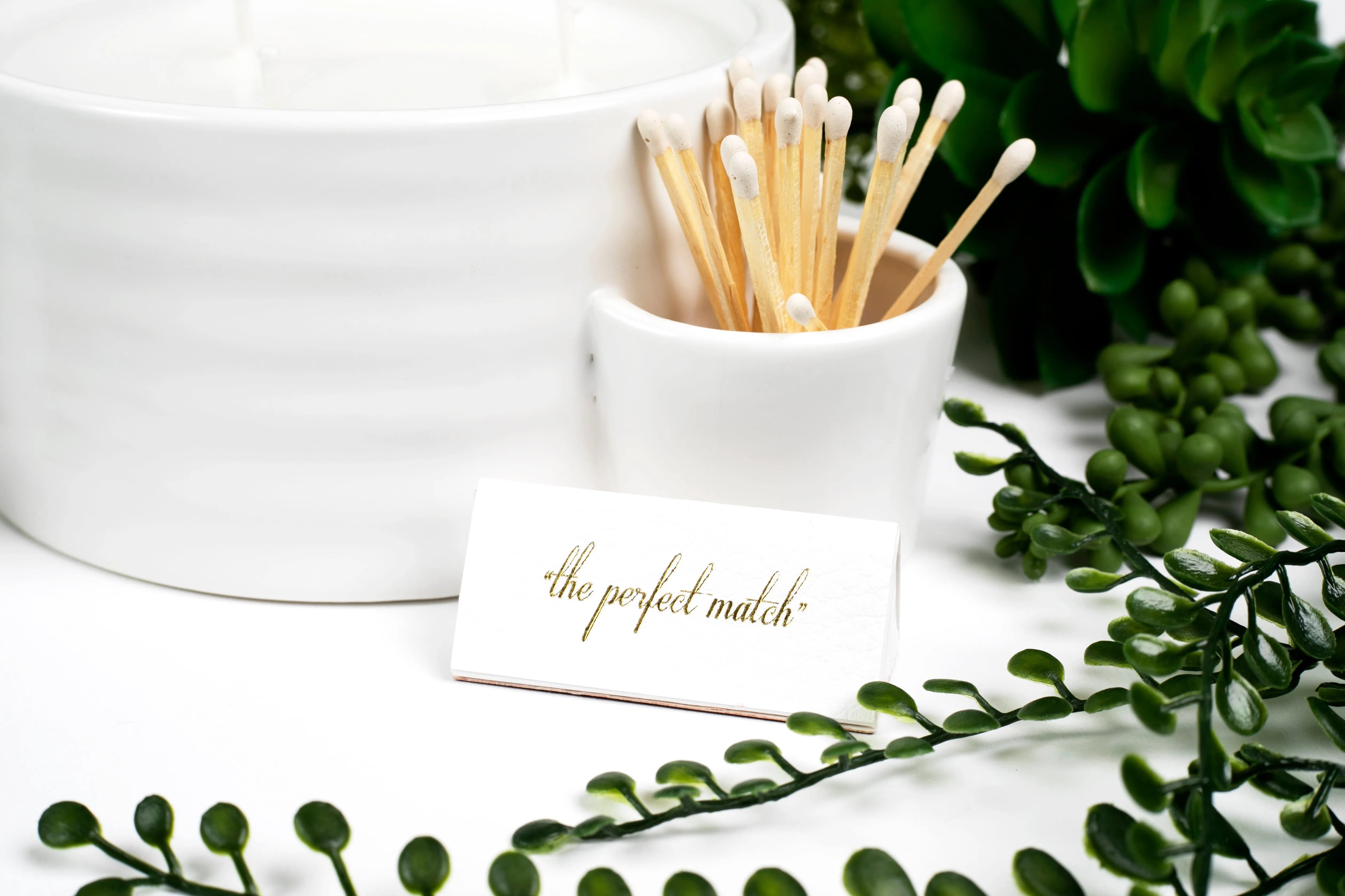 Palm Desert ceramic match holder with white matches and a card that says "the perfect match" next to decorative greenery.