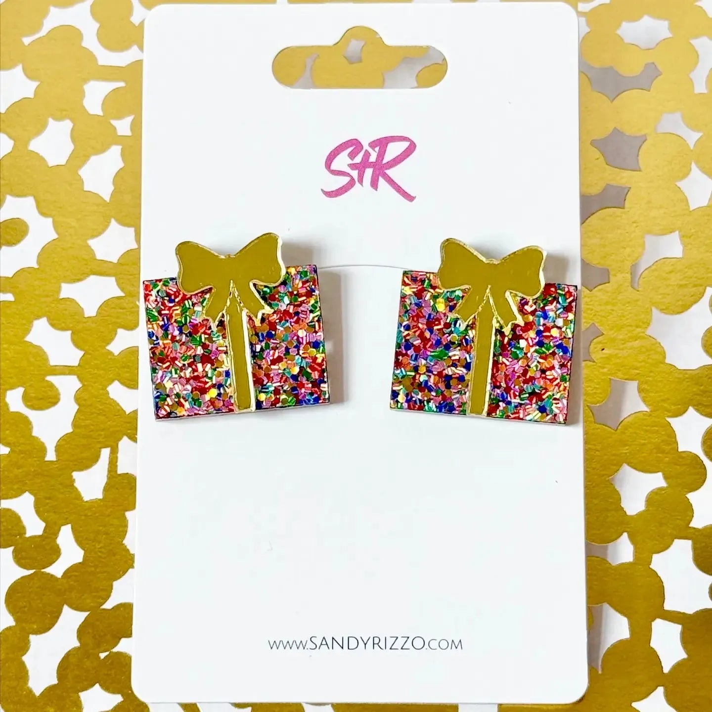 Pair of square Christmas present confetti stud earrings with gold bows, displayed on a white card with gold background.