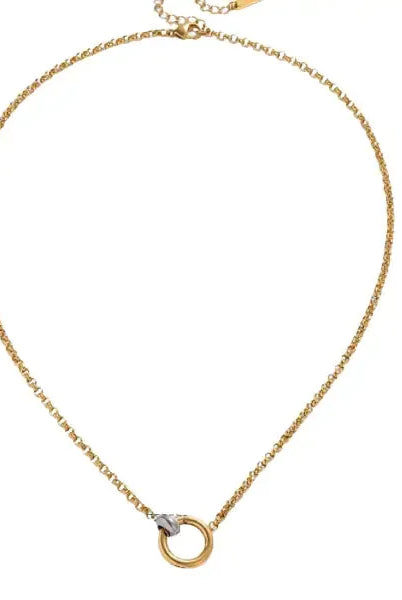 Gold chain necklace with a circular charm featuring a two-tone push-lock closure detail.