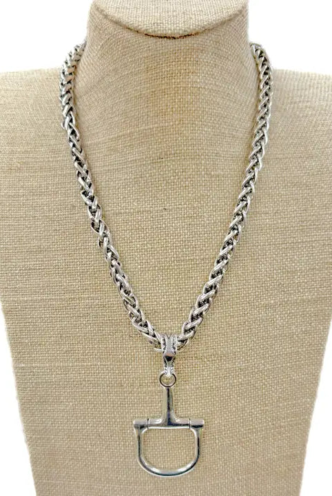 Silver horse bit necklace with a thick, braided chain and a detailed D-ring bit pendant.