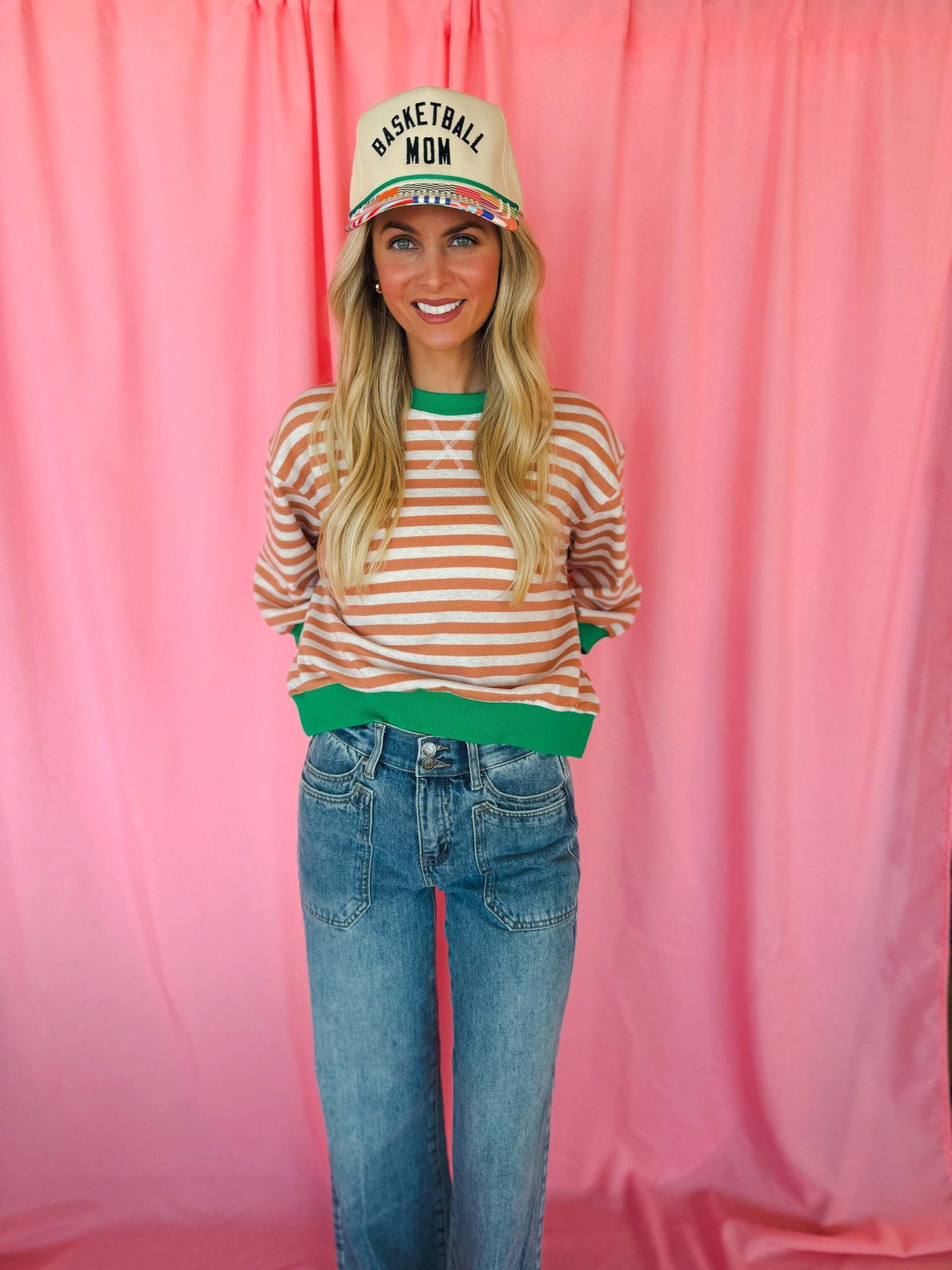 Entro apricot and white striped long-sleeve top with green trim and collar, paired with blue denim jeans.