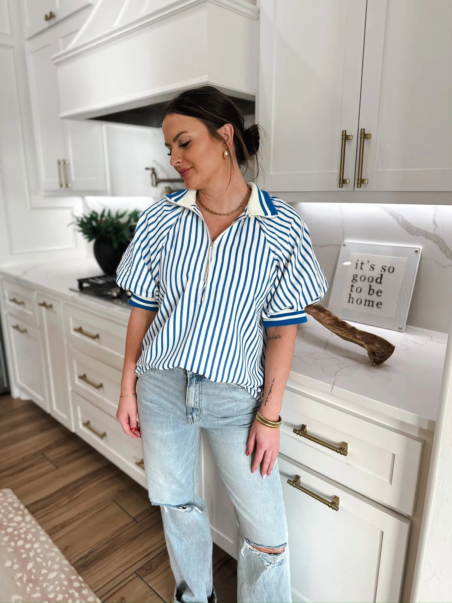 Entro blue and white vertical striped zip V neck short sleeve top with a white collar. The top has a gold zipper detail