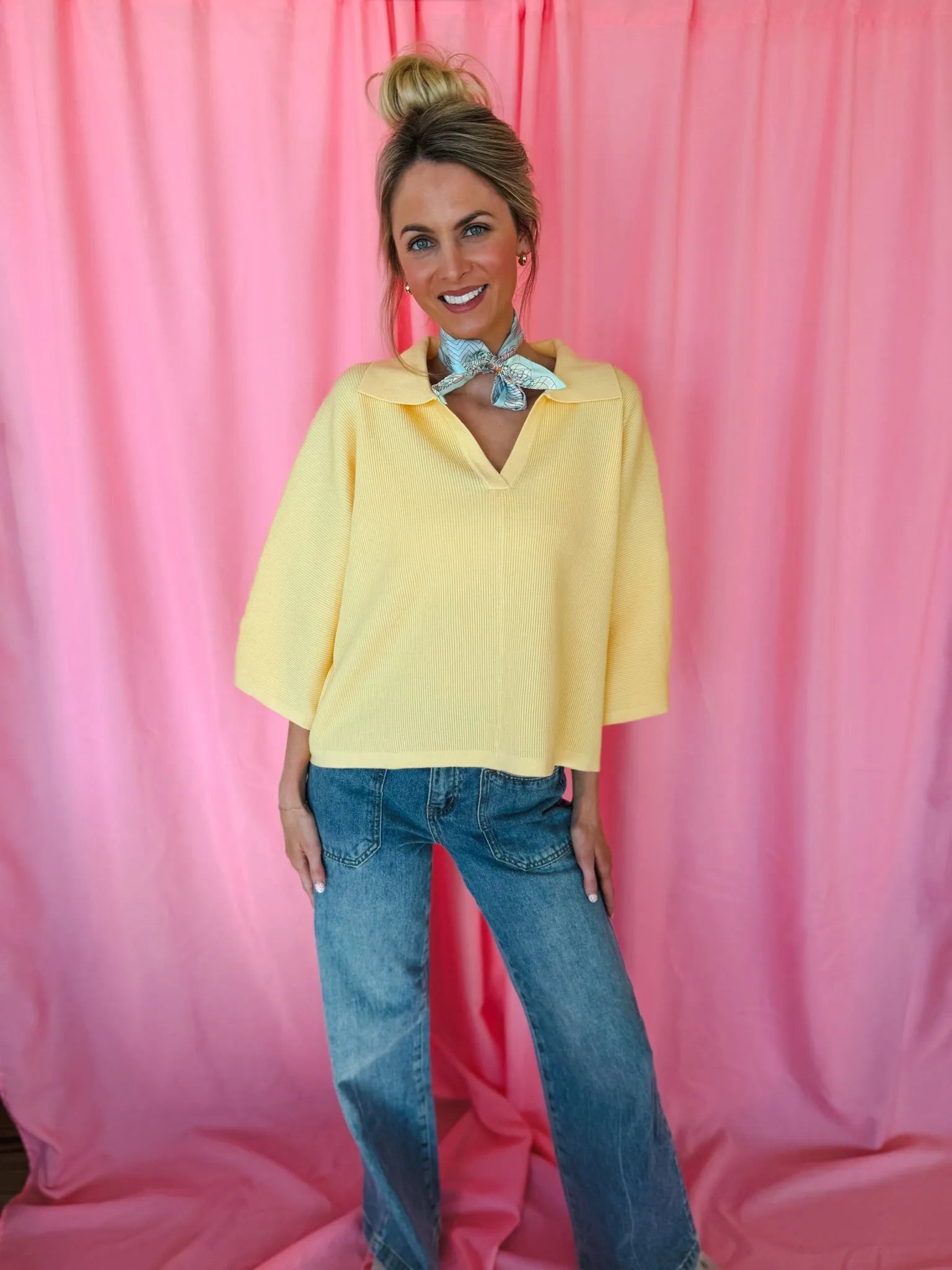 Entro butter yellow ribbed sweater top with collar, V-neck, and 3/4 sleeves, worn with blue jeans.
