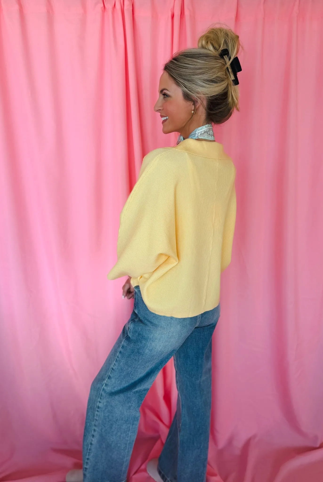 Entro Butter Yellow Ribbed Sweater Top, collared with wide dolman sleeves, modeled by a woman with blue jeans.