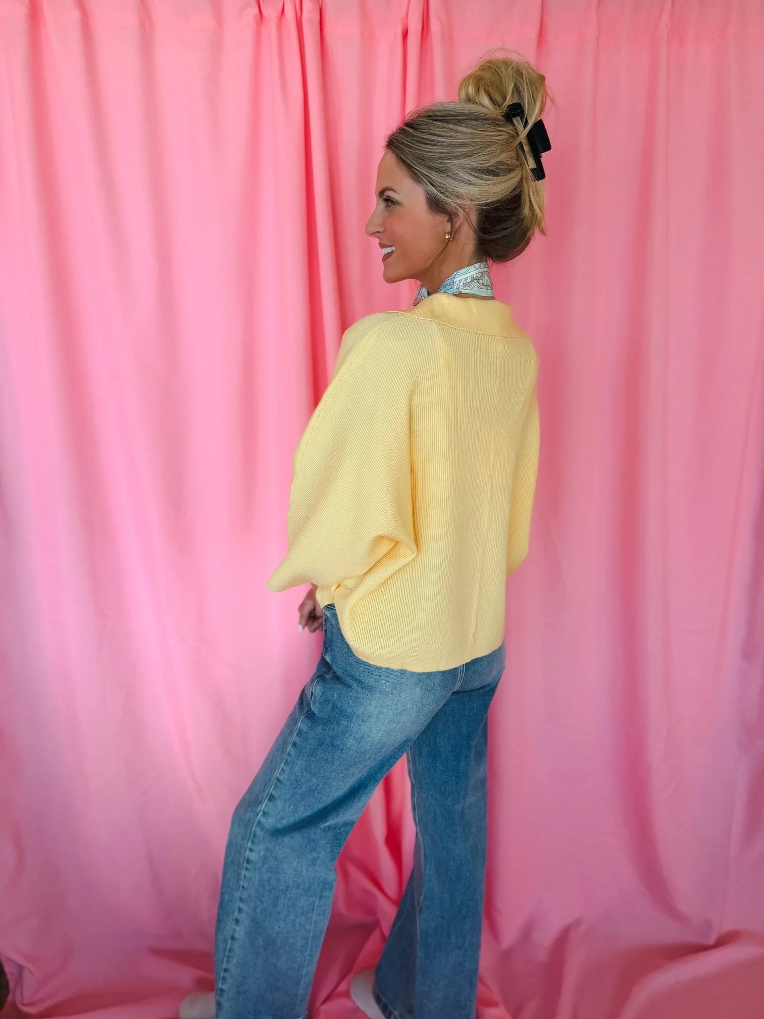 Entro Butter Yellow Ribbed Sweater Top, collared with wide dolman sleeves, modeled by a woman with blue jeans.