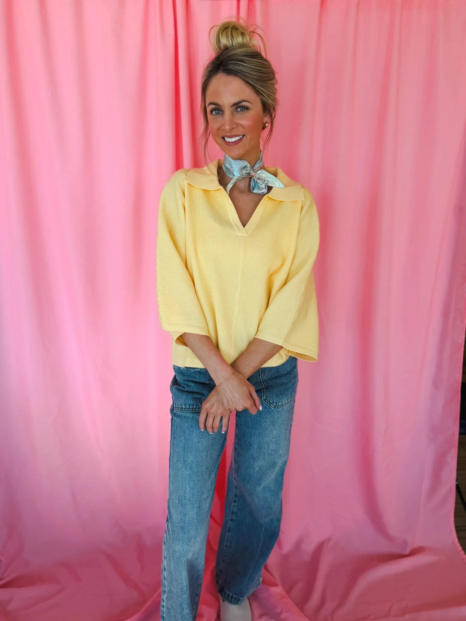 Entro butter yellow ribbed sweater top with collar and v-neck, three-quarter sleeves, paired with light wash jeans and a