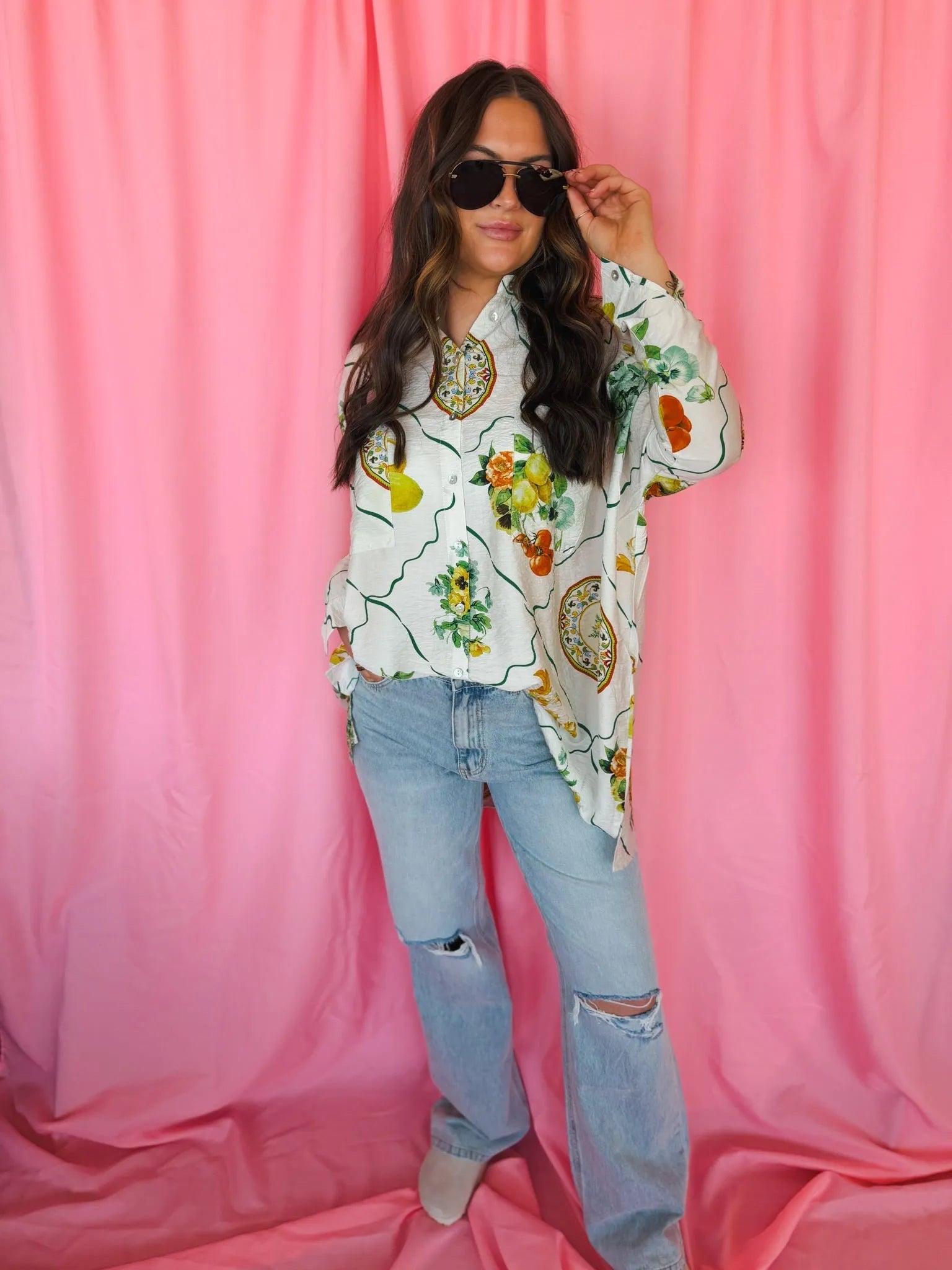 Entro Citrus Garden oversized button-down top with a white background, featuring a vibrant fruit and floral print. The