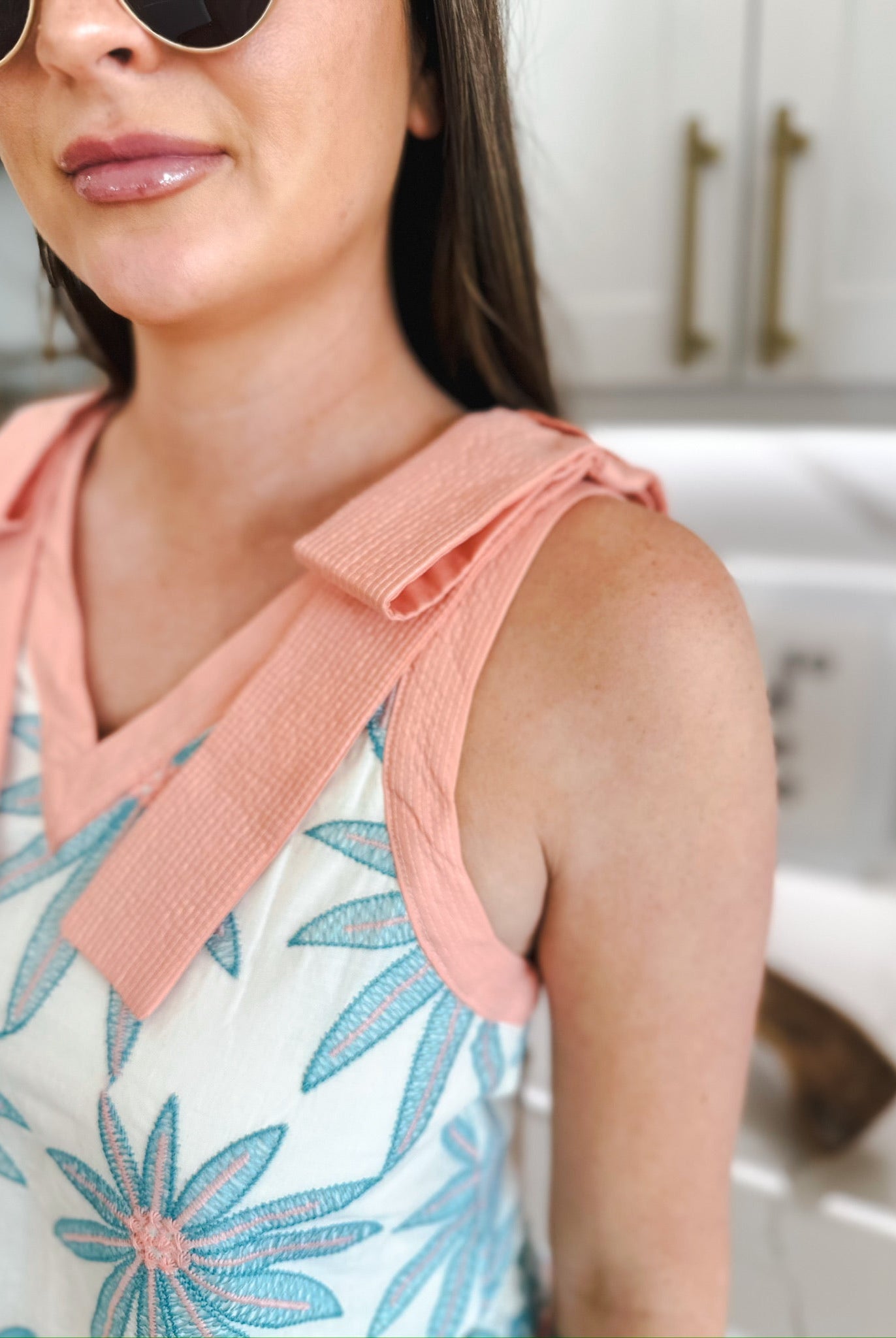 Entro white blouse with blue and pink embroidered floral print, featuring coral pink collar and shoulder ties.