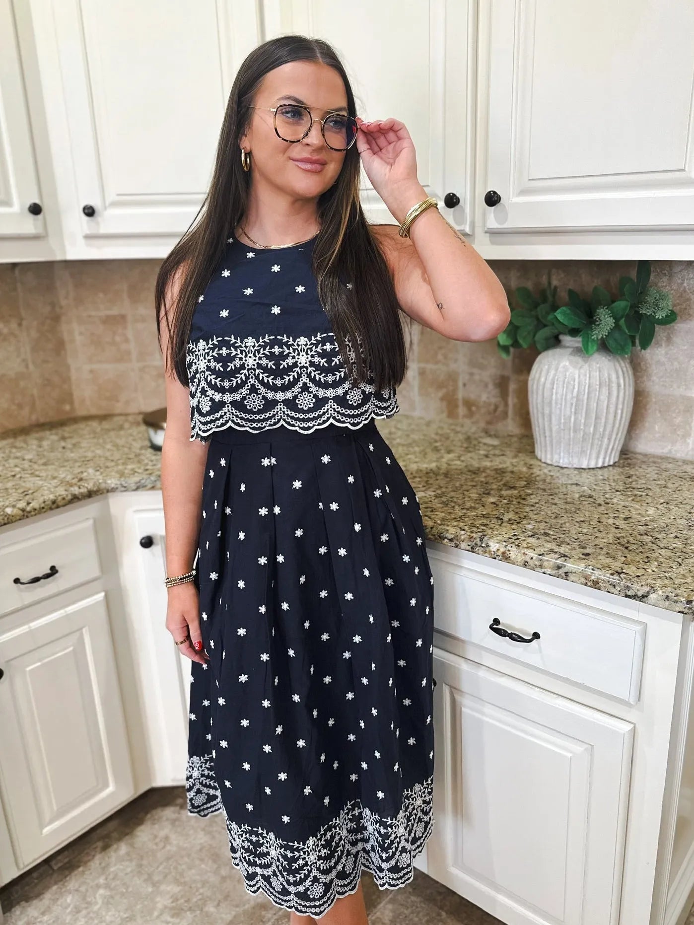 Entro navy blue sleeveless midi dress with white eyelet and floral embroidery. Pleated skirt.