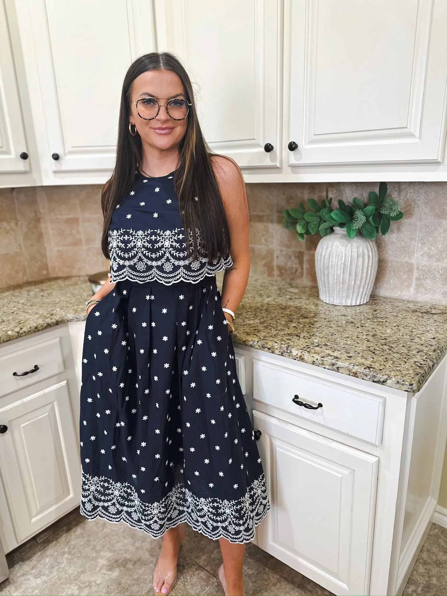 Entro navy blue sleeveless midi dress with white eyelet and floral embroidery. Sleeveless with a tiered skirt.