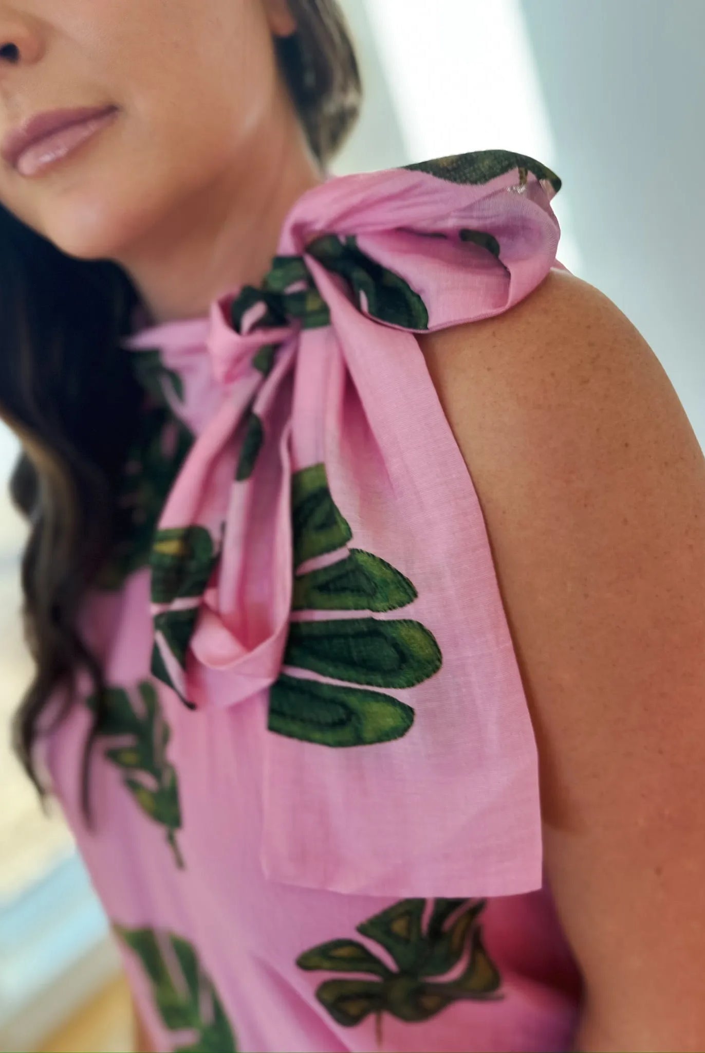 Entro pink maxi dress with a tie-neck and a tropical green palm leaf print.