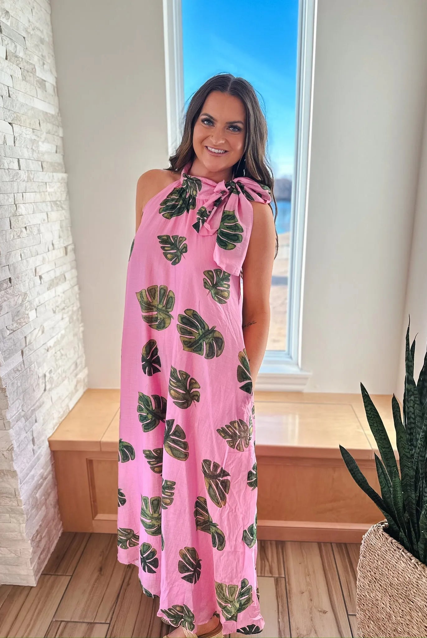 Entro pink maxi dress with a palm leaf print and a tie neck, shown on a woman.