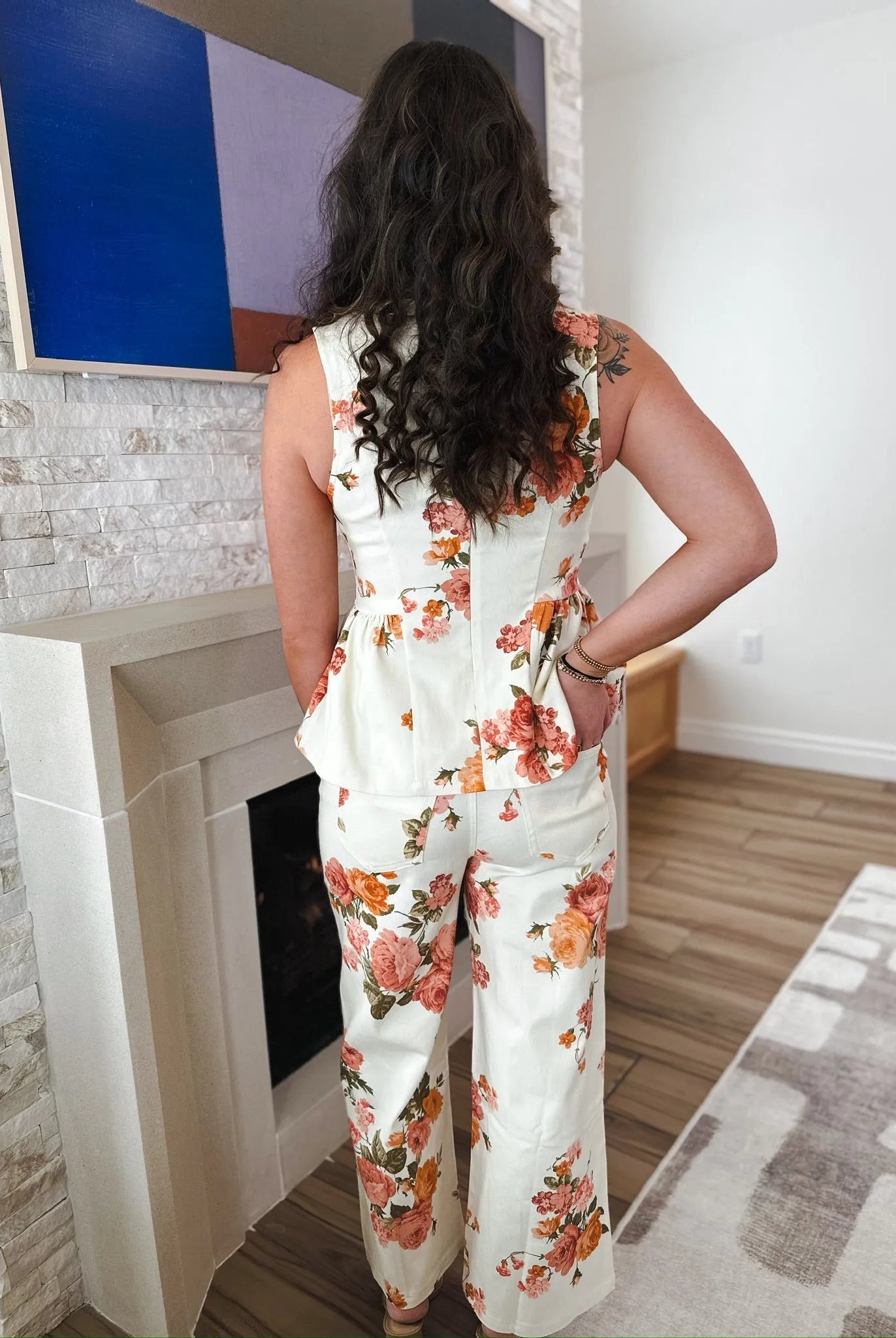 Entro white denim floral top and pants set, featuring a peplum top with a zip back and flared trousers, adorned with a