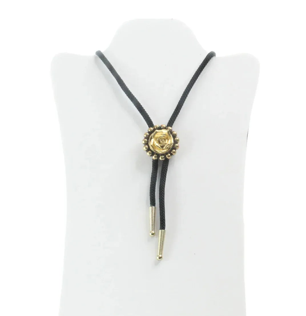 Gold rose bud bolo necklace with a black braided cord and gold tips.
