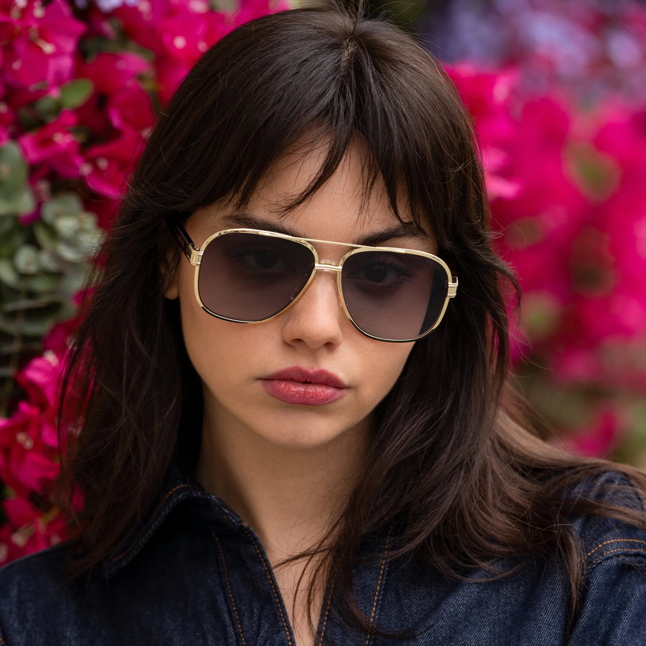 FREYRS CARTER unisex aviator sunglasses with gold metal frame and gradient brown lenses worn by a woman with dark hair