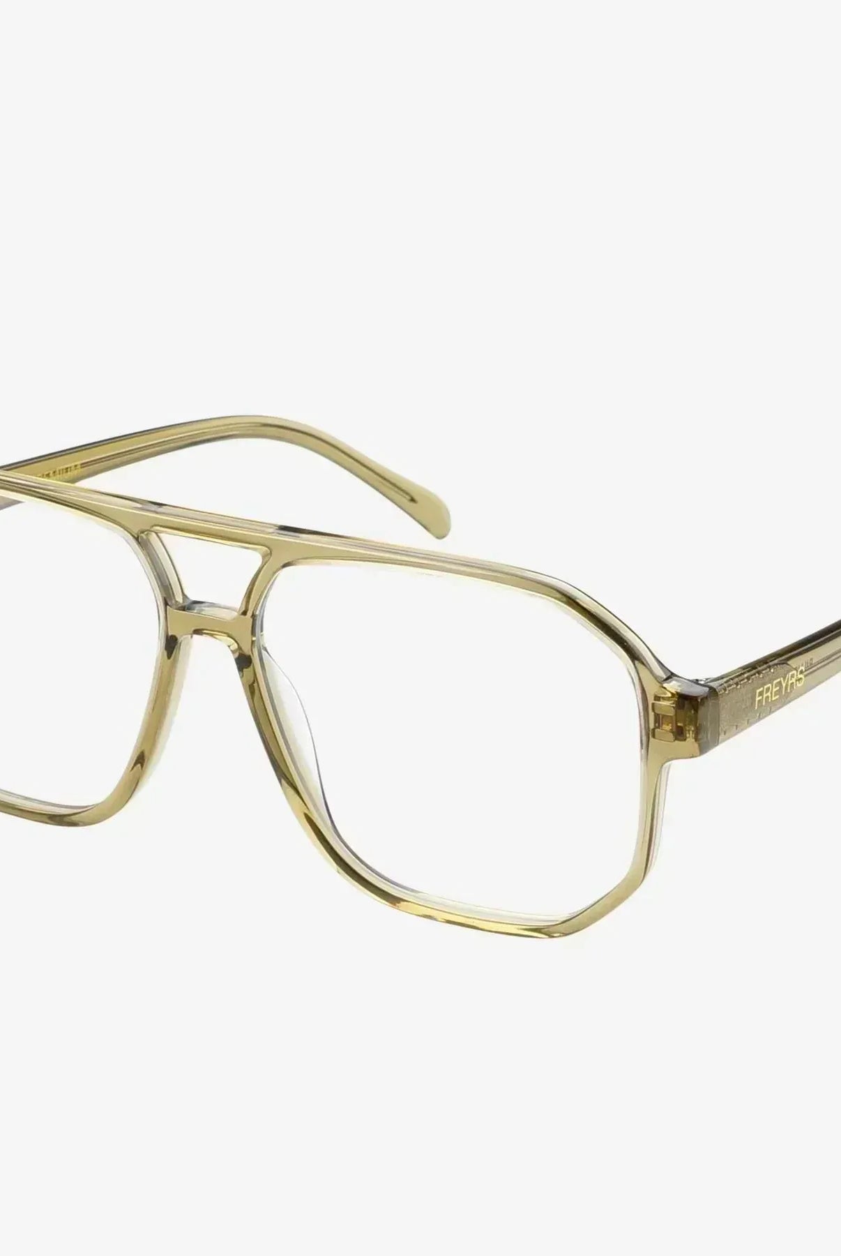 Freyrs Billie aviator-style blue light filtering glasses with clear lenses and translucent olive green frames on a white