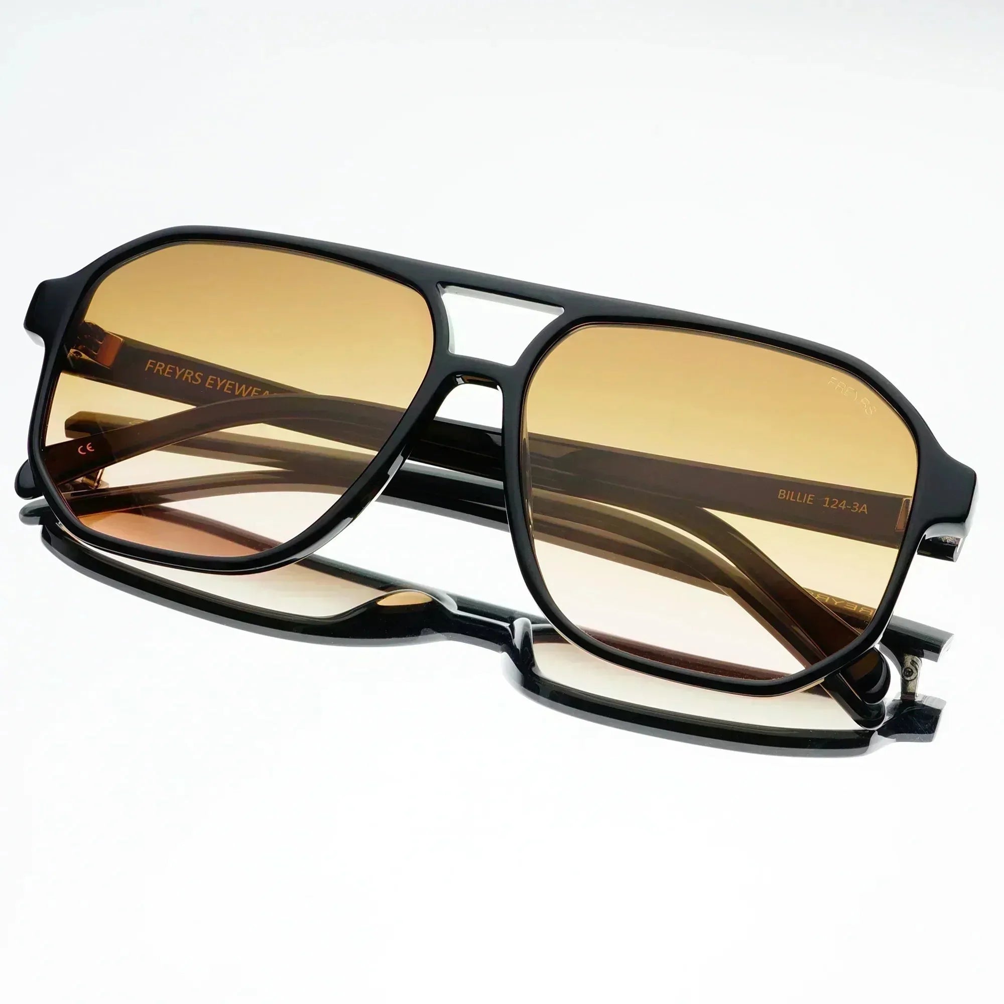 Freyrs Billie unisex aviator sunglasses with black frames and gradient brown lenses on a white background.