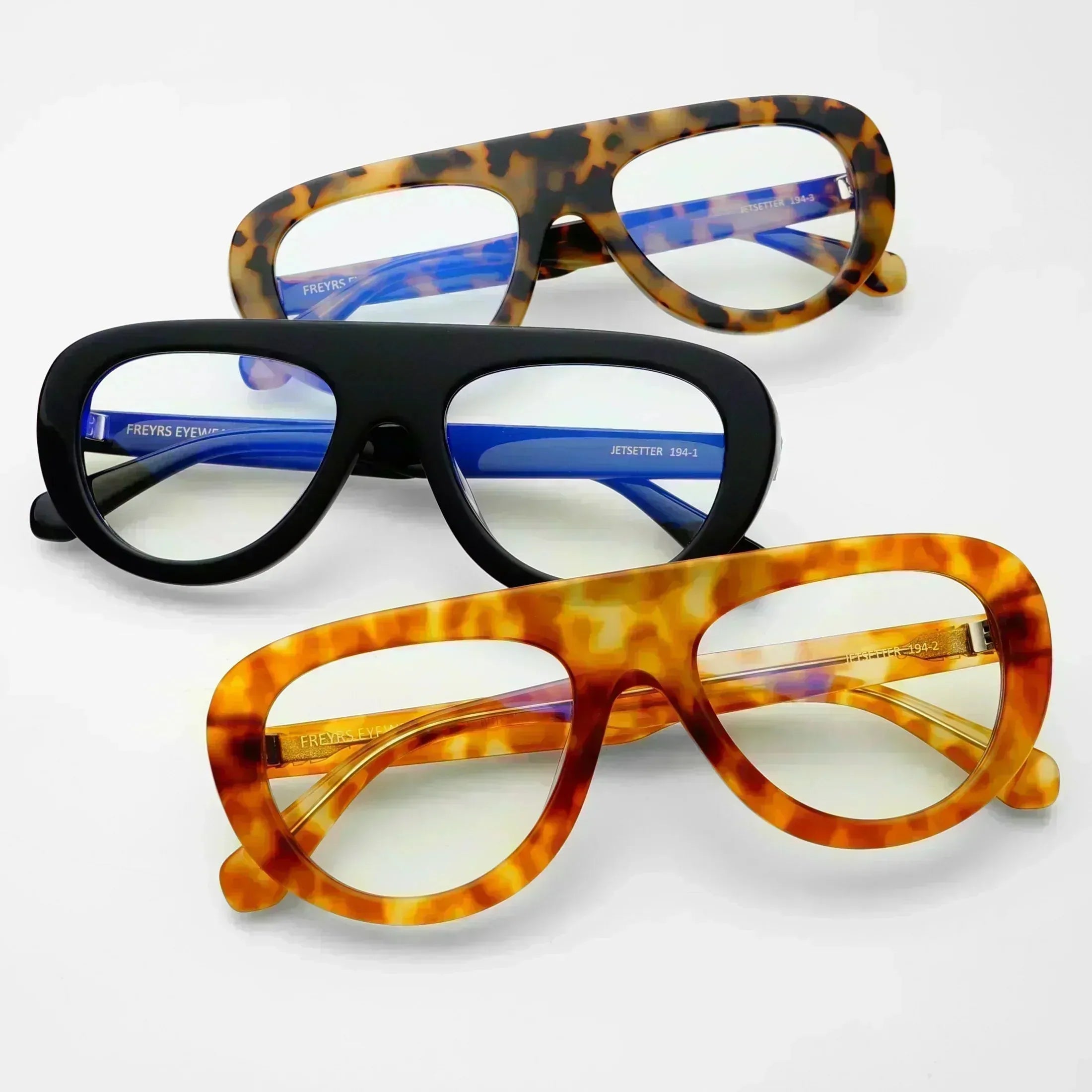 Freyrs Jetsetter blue light filtering glasses in tortoise, black, and amber tortoise patterns. Clear lenses.