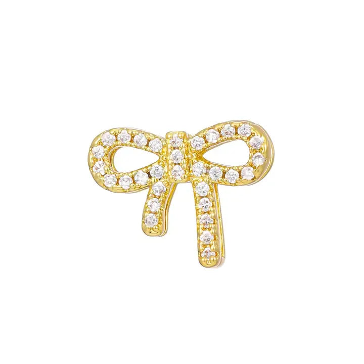 Gold plated bow tie charm for bracelet, encrusted with small cubic zirconia stones.