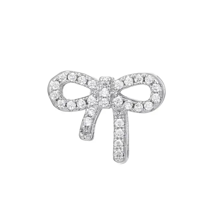Silver plated CZ slider charm for bracelets, shaped like a sparkling bow tie with dangling ends.