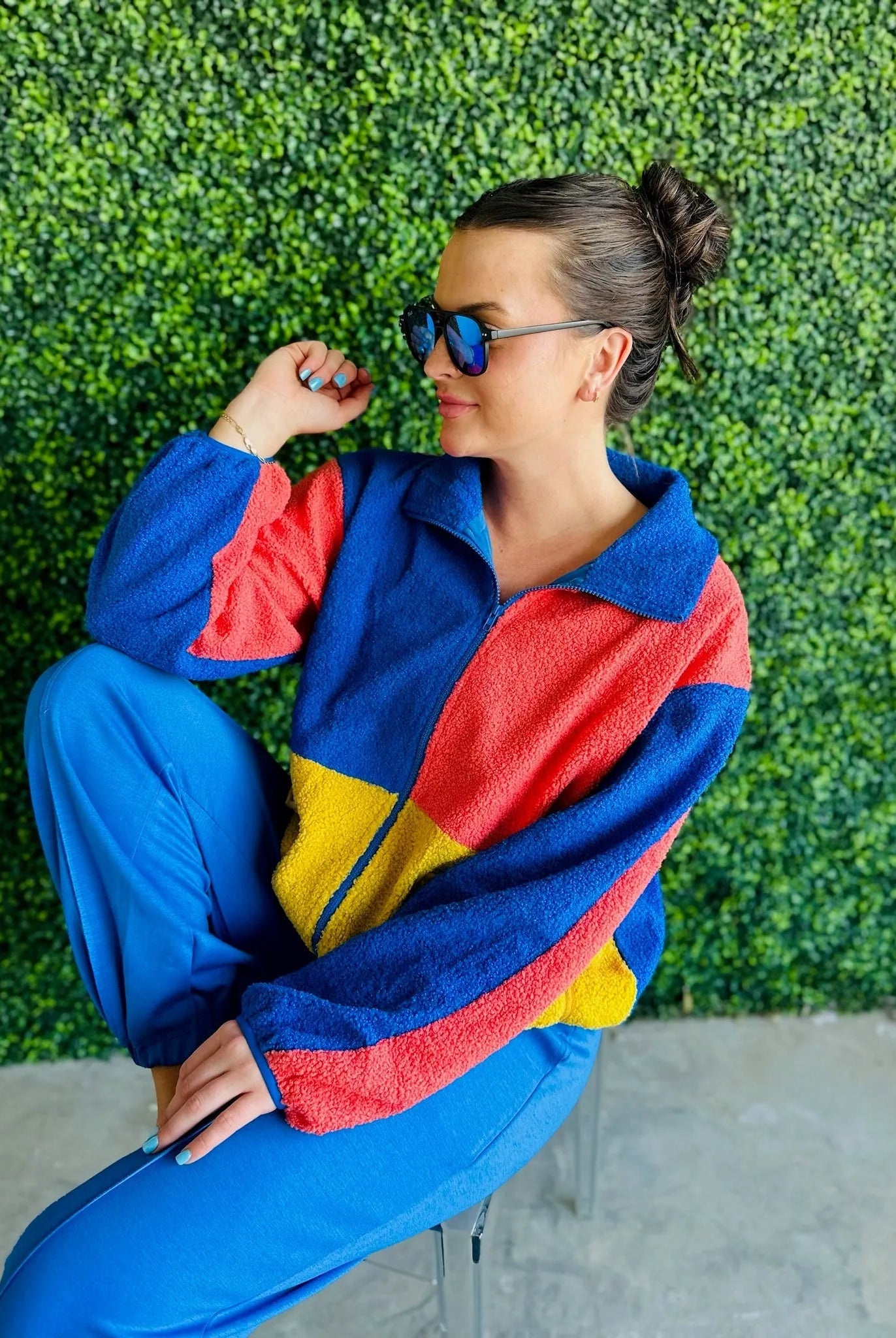 J.anna Sherpa Thunder color block zip-up jacket. Features blue, red, and yellow color blocking. Model wears sunglasses and
