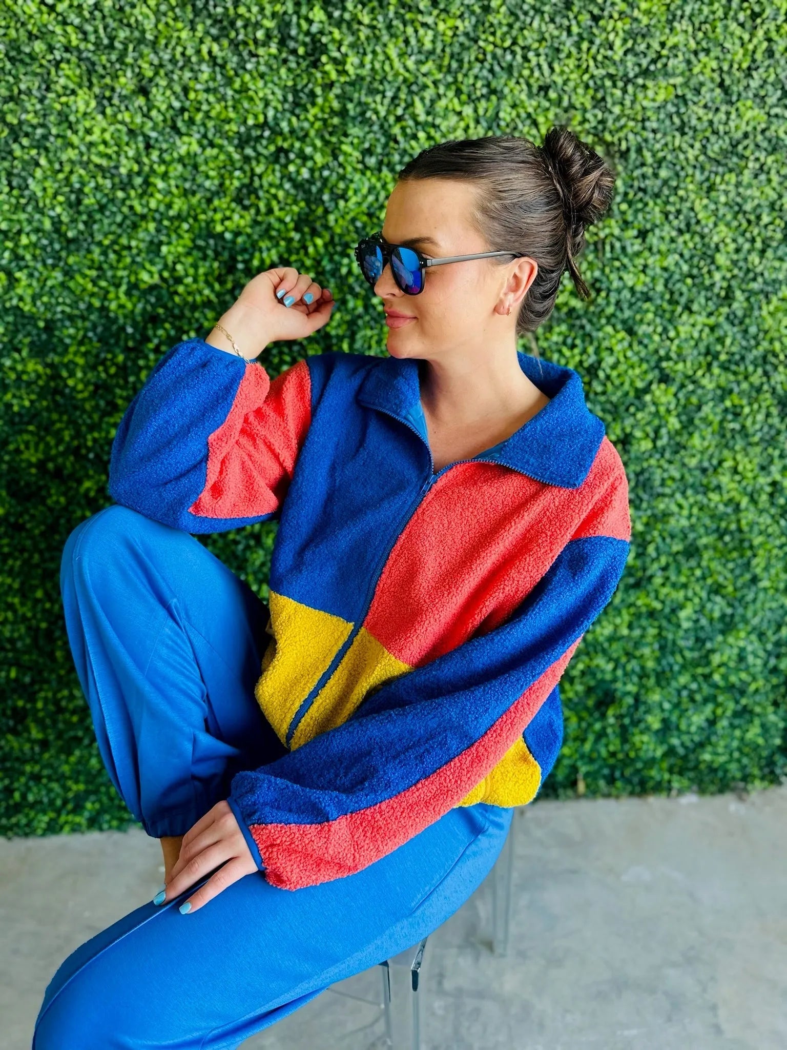 J.anna Sherpa Thunder color block zip-up jacket. Features blue, red, and yellow color blocking. Model wears sunglasses and