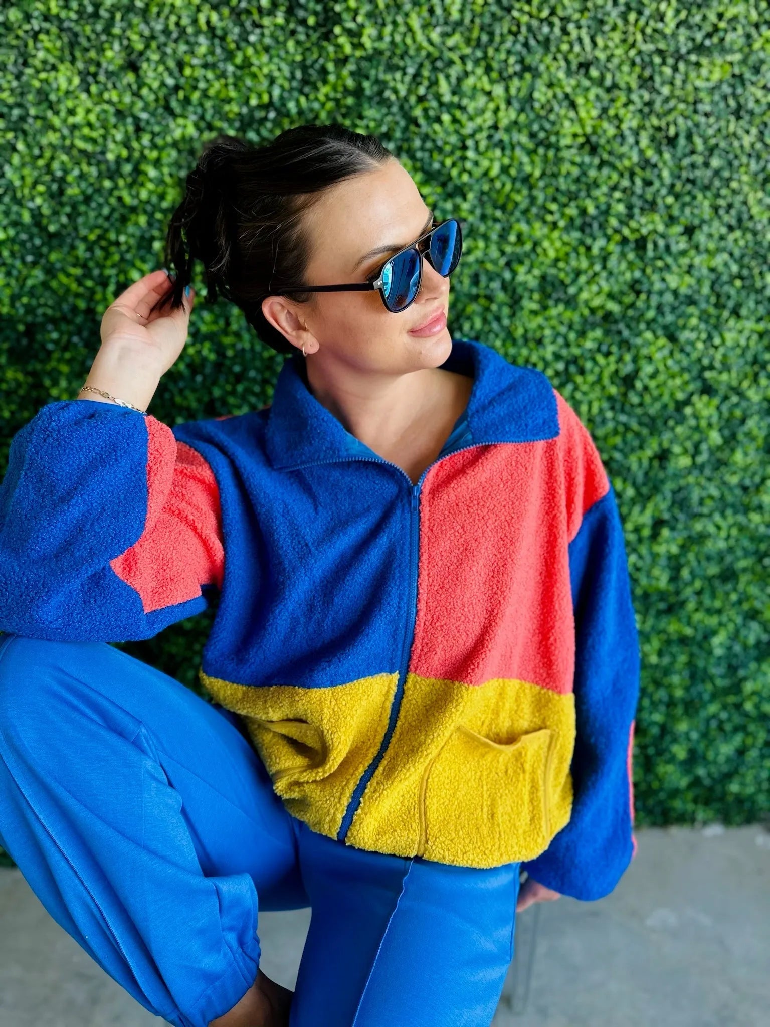 J.anna Sherpa Thunder jacket with color block design in blue, coral, and yellow. Full zip-up with collar and pocket.
