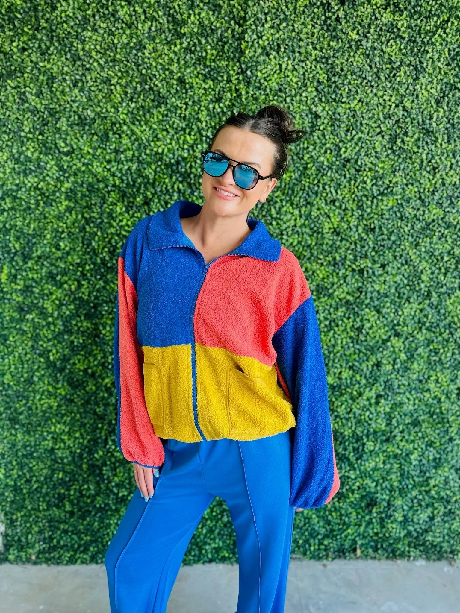 J.anna Sherpa zip-up jacket with color block design in blue, red, and yellow. Features a zippered front and textured sherpa