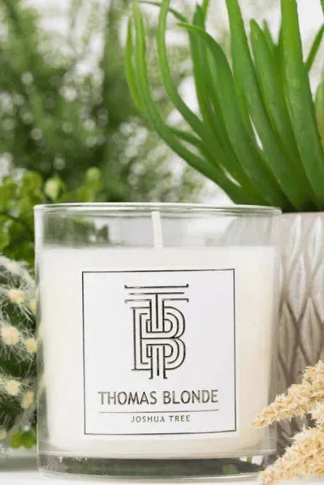 Thomas Blonde Joshua Tree soy wax candle in a clear glass jar with a white label featuring a black logo and text