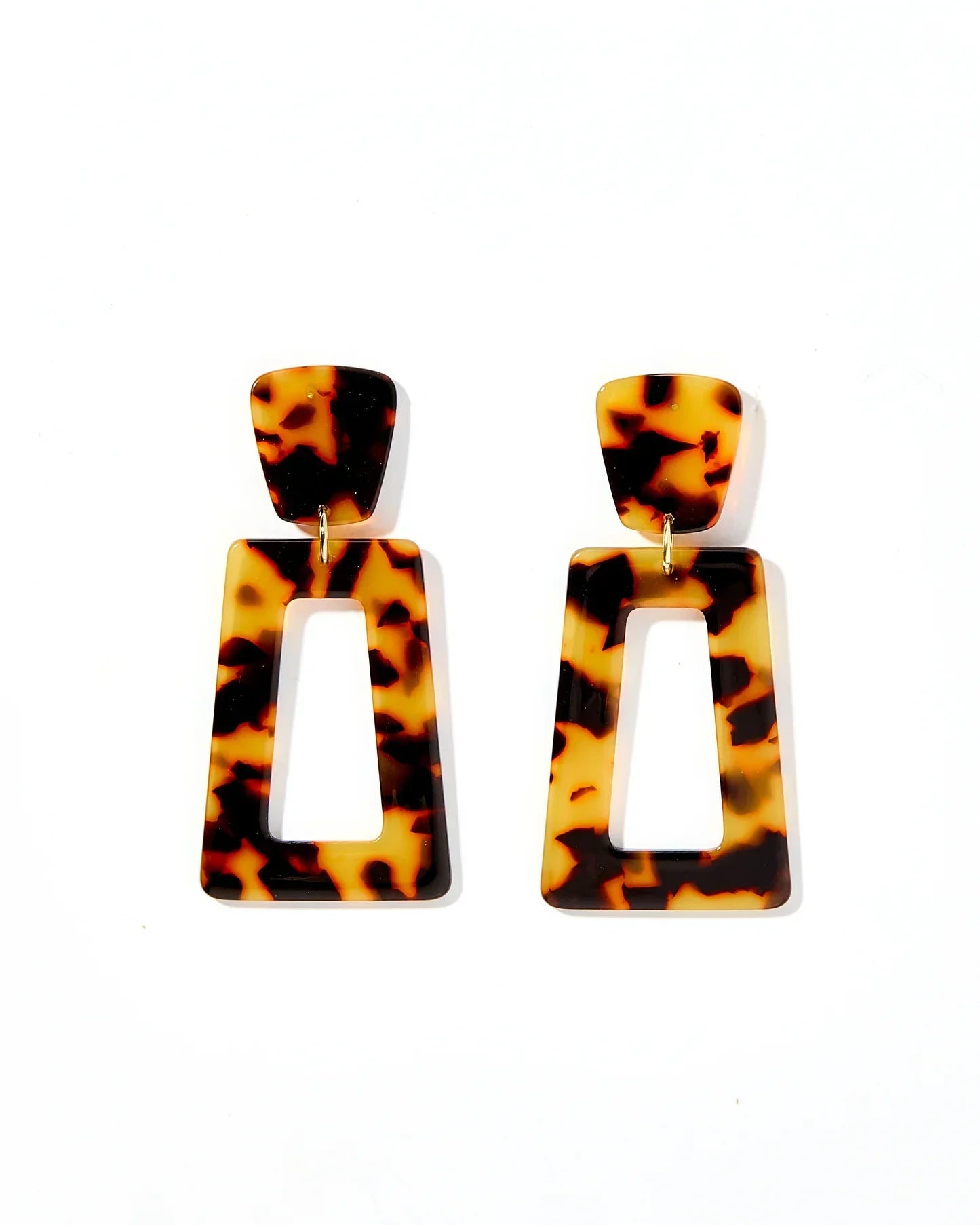 Kennedy Brown tortoise pattern geometric statement earrings with rectangular cutouts, hanging from gold posts.