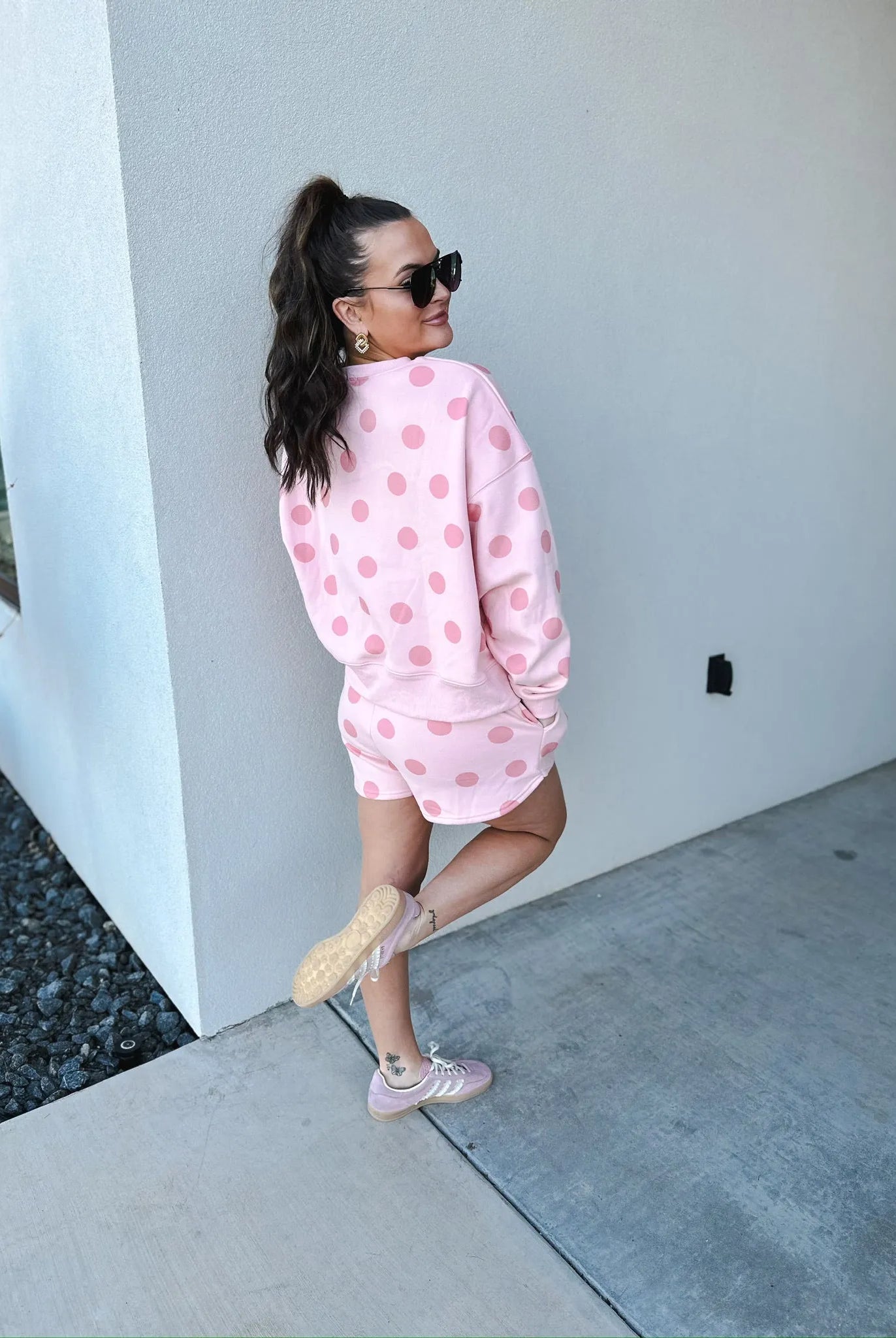 Poppy & Pine blush pink polka dot sweatshirt and matching shorts set. shorts worn by a woman with a high ponytail and