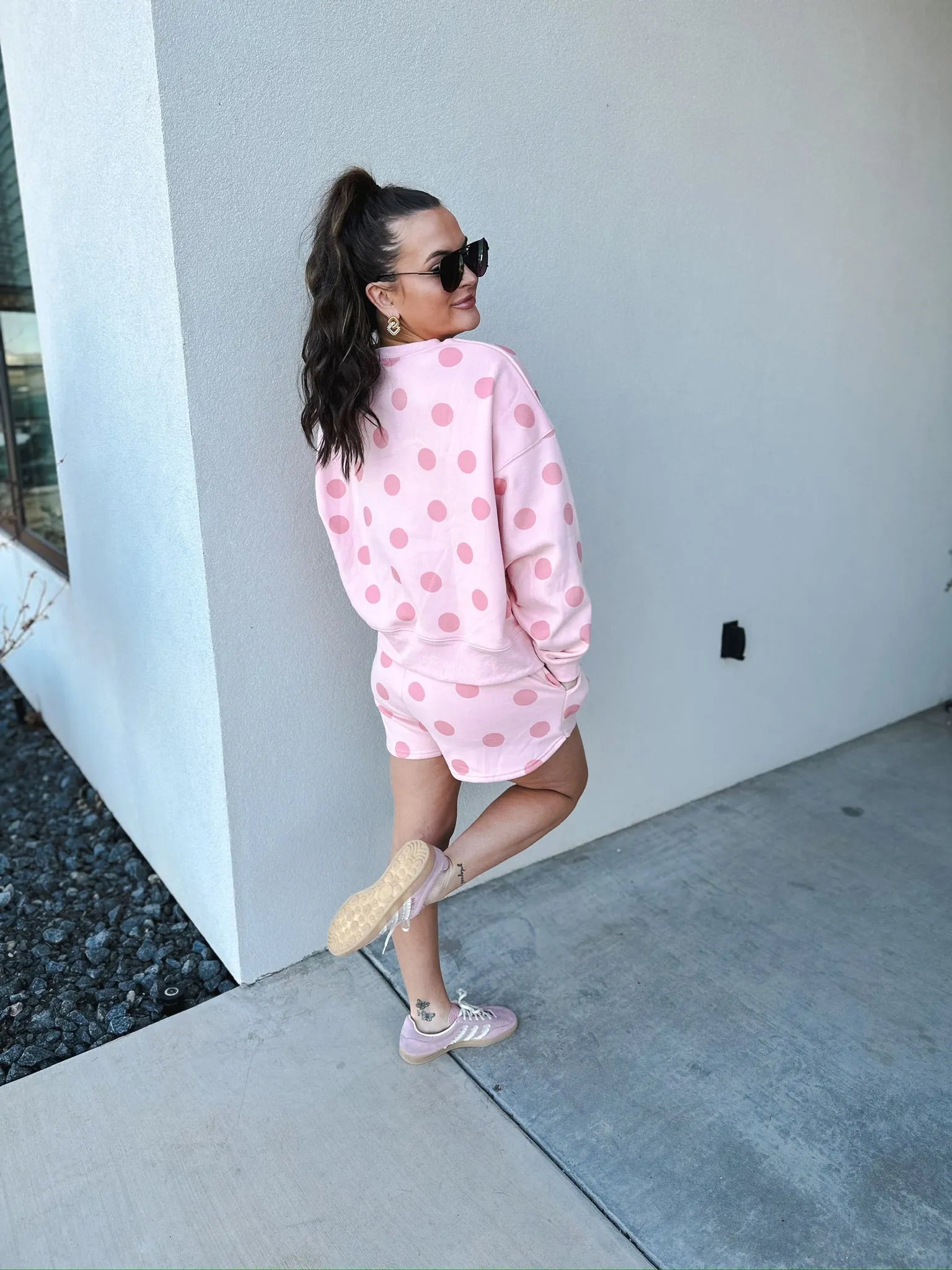 Poppy & Pine blush pink polka dot sweatshirt and matching shorts set. shorts worn by a woman with a high ponytail and