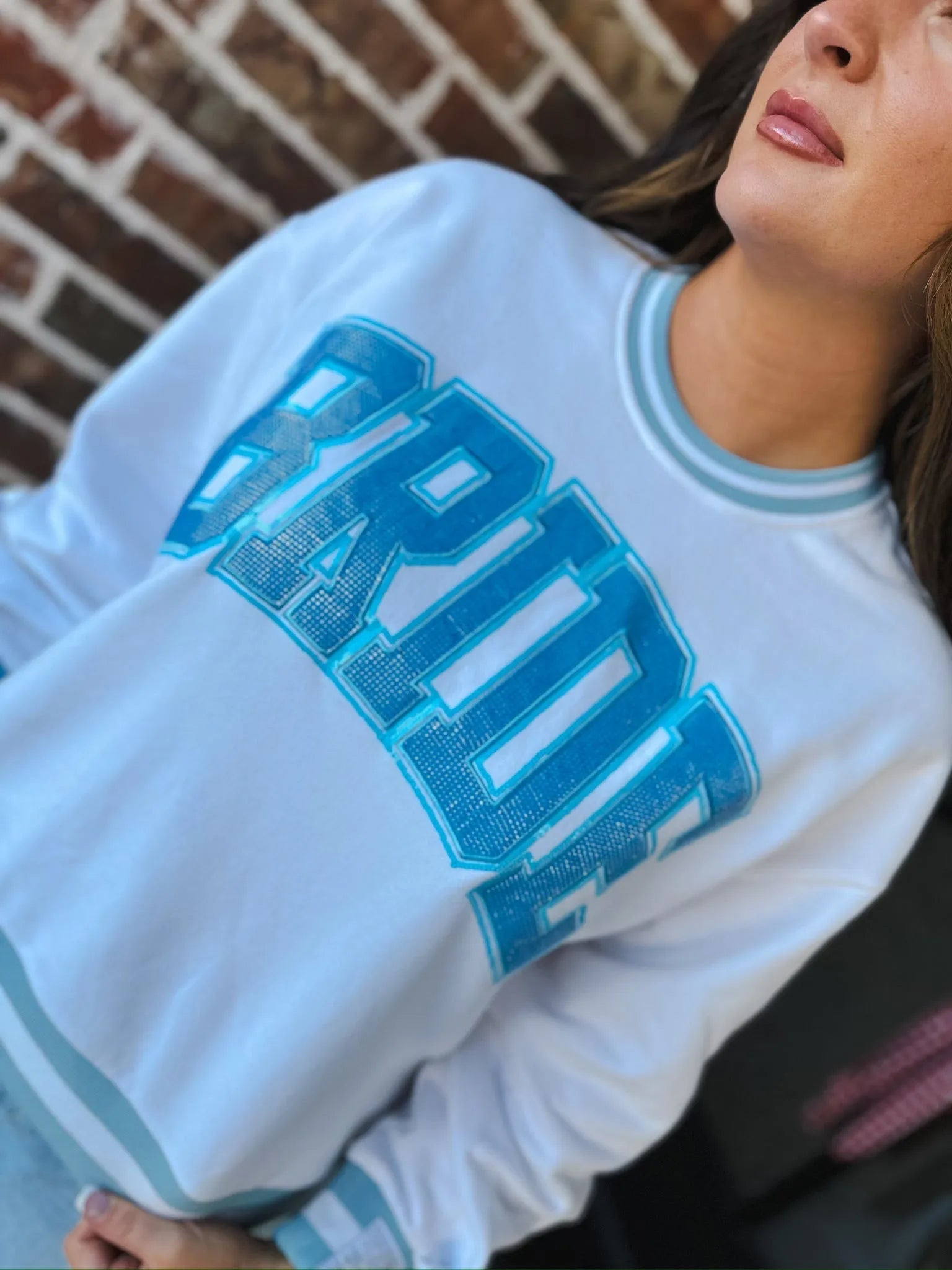 White Queen Of Sparkles Bride sweatshirt with bold blue "BRIDE" text and rhinestones. Striped cuffs and neckline.