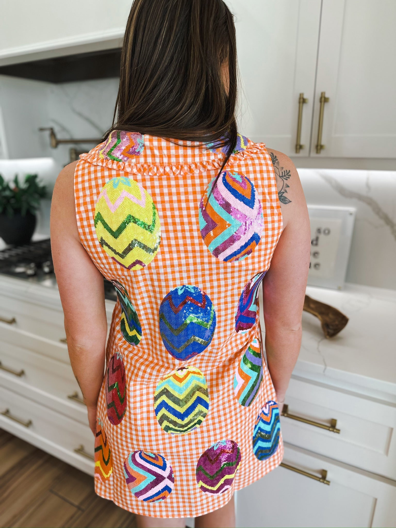 Queen of Sparkles orange gingham sequin Easter egg dress. Features colorful sequin eggs with chevron patterns.