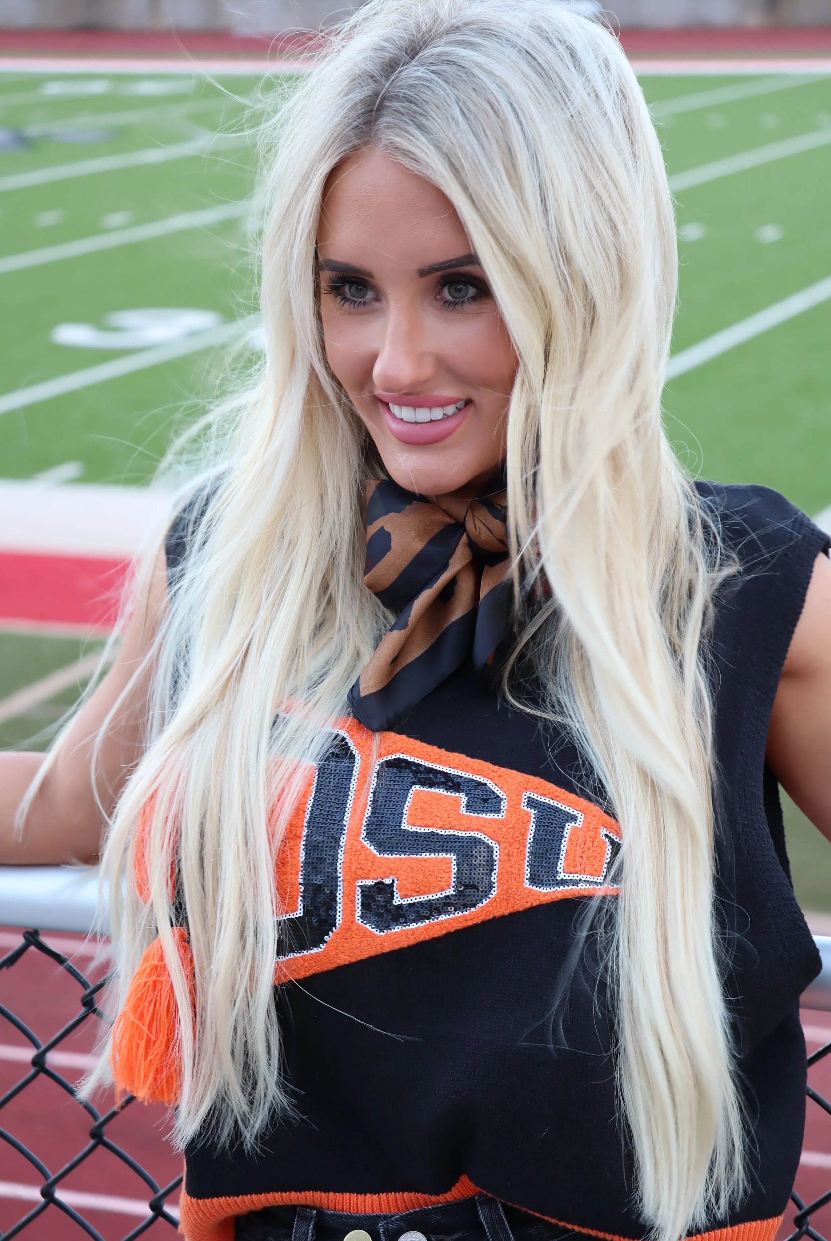 Queen of Sparkles OSU Pennant Sweater Tank with sequined OSU logo on black knit. Features a brown and black patterned scarf.