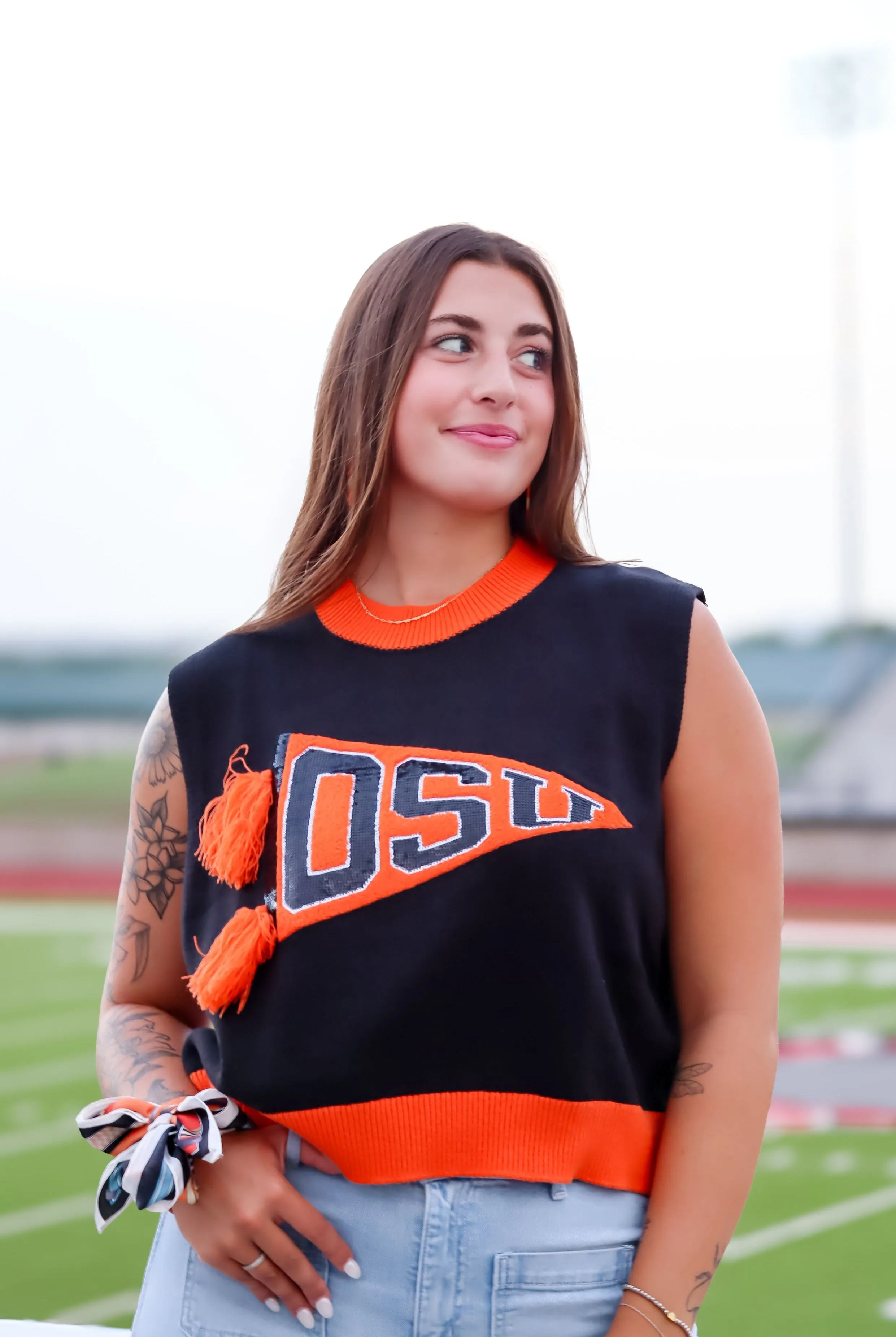 Sleeveless black sweater tank with orange trim, featuring an orange pennant graphic with 'OSU' in navy blue block letters