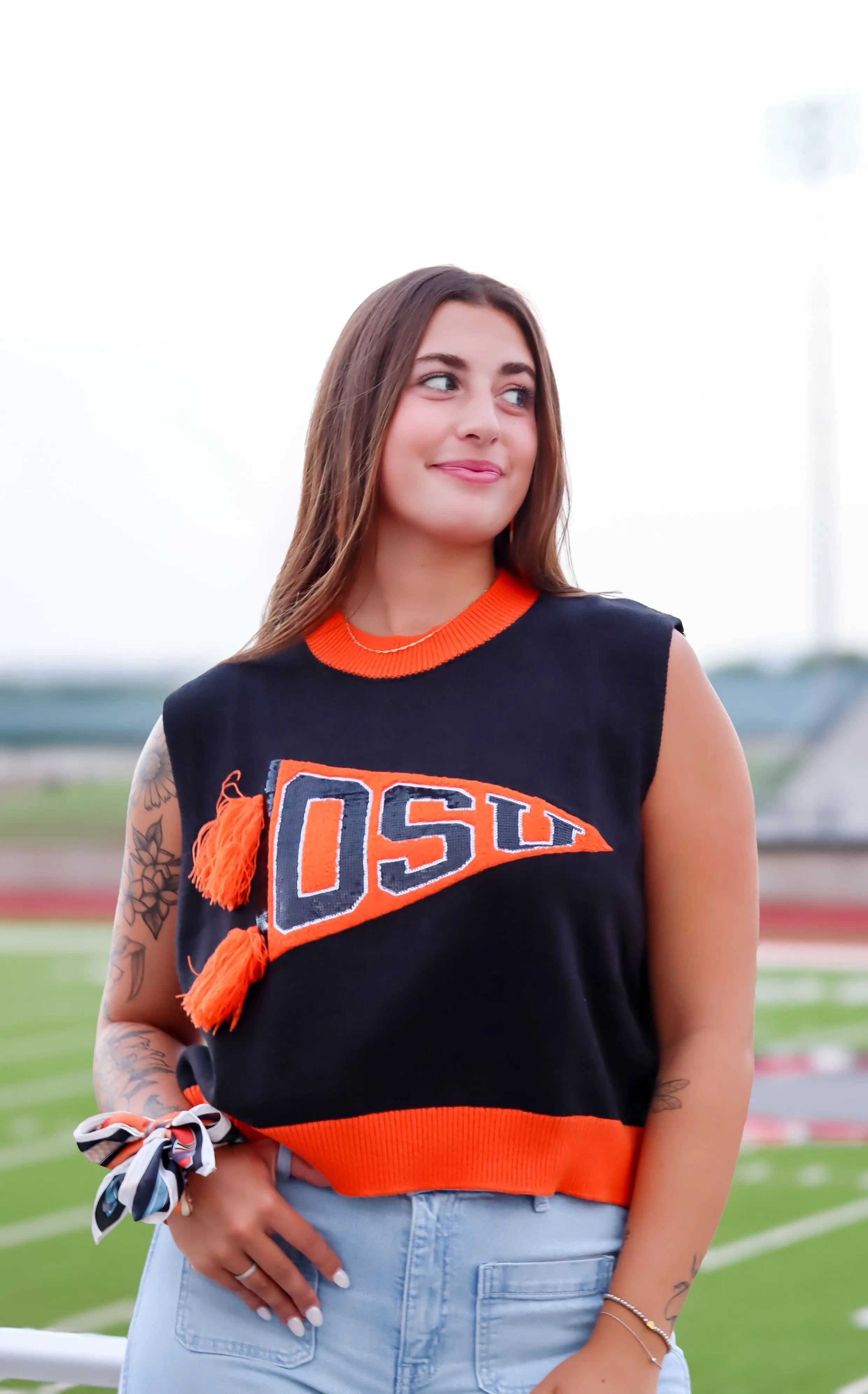 Sleeveless black sweater tank with orange trim, featuring an orange pennant graphic with 'OSU' in navy blue block letters