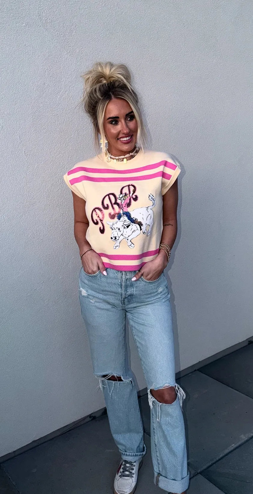 Queen of Sparkles tan knit tank top with pink stripes, featuring a PBR bull rider graphic. Modeled with light wash
