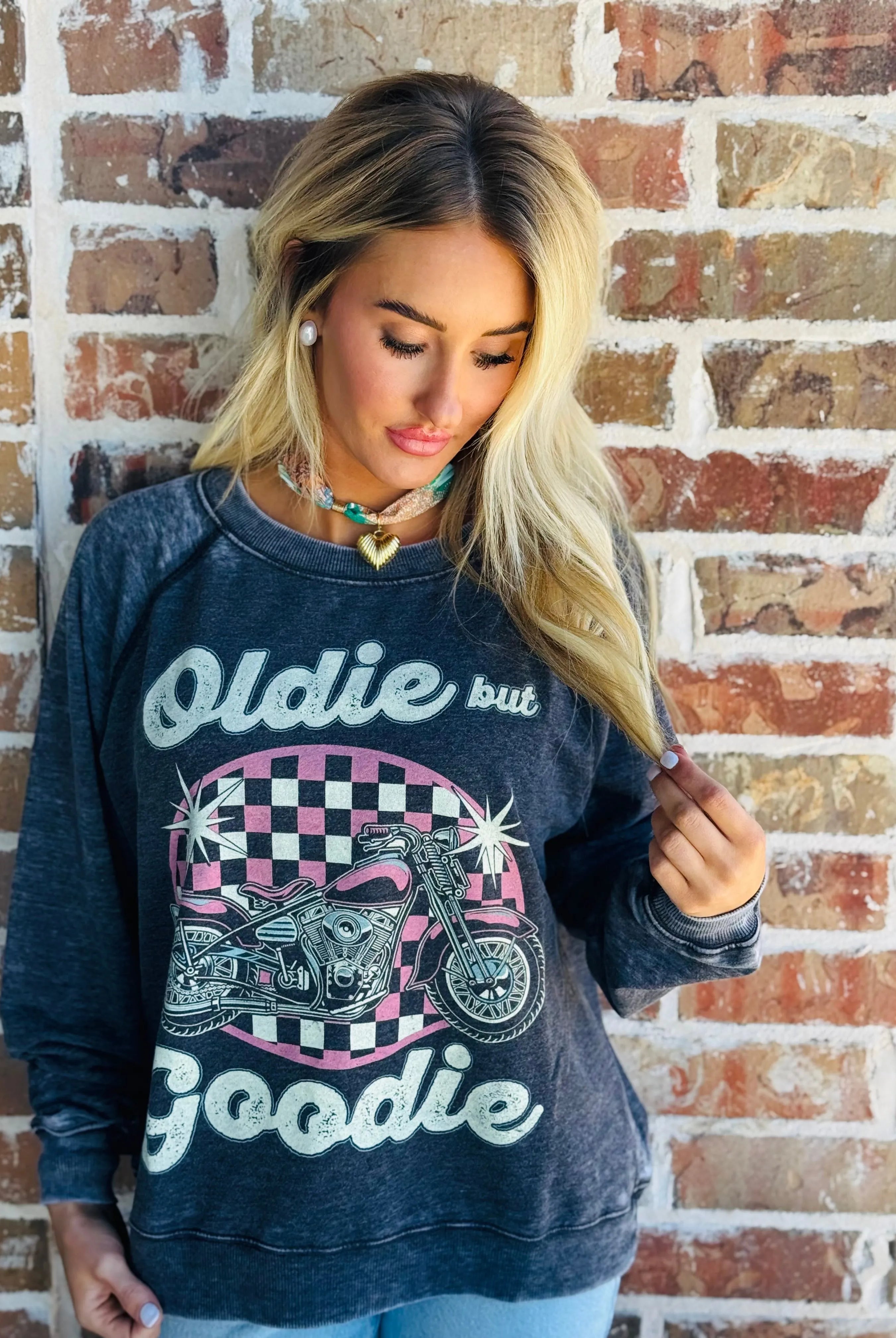 Recycled Karma "Oldie but Goodie" charcoal graphic sweatshirt with a pink checkered oval featuring a motorcycle and stars.