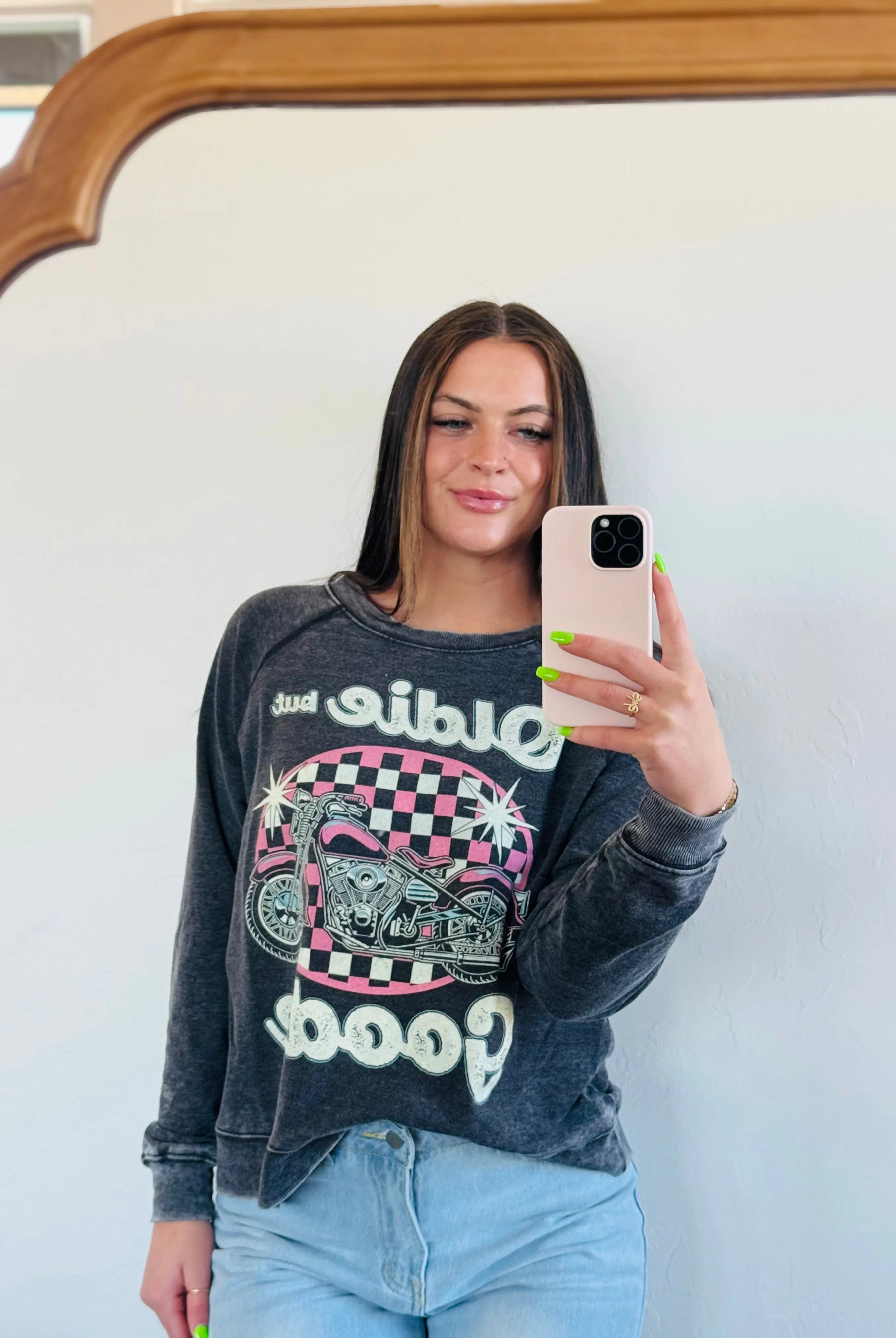 Recycled Karma "Oldie But Goodie" graphic sweatshirt featuring a pink and black checkerboard background with a pink