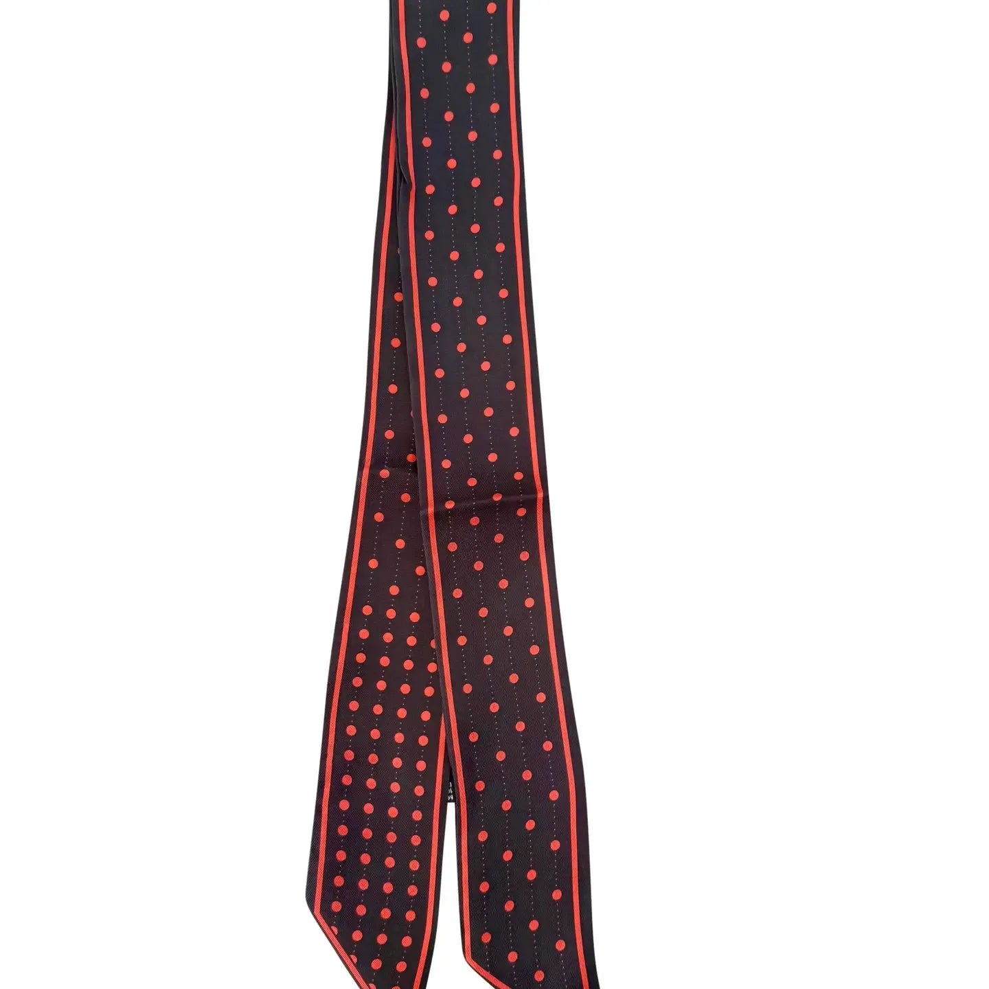Black and red polka dot skinny scarf with vertical stripe accents, tied in a knot.