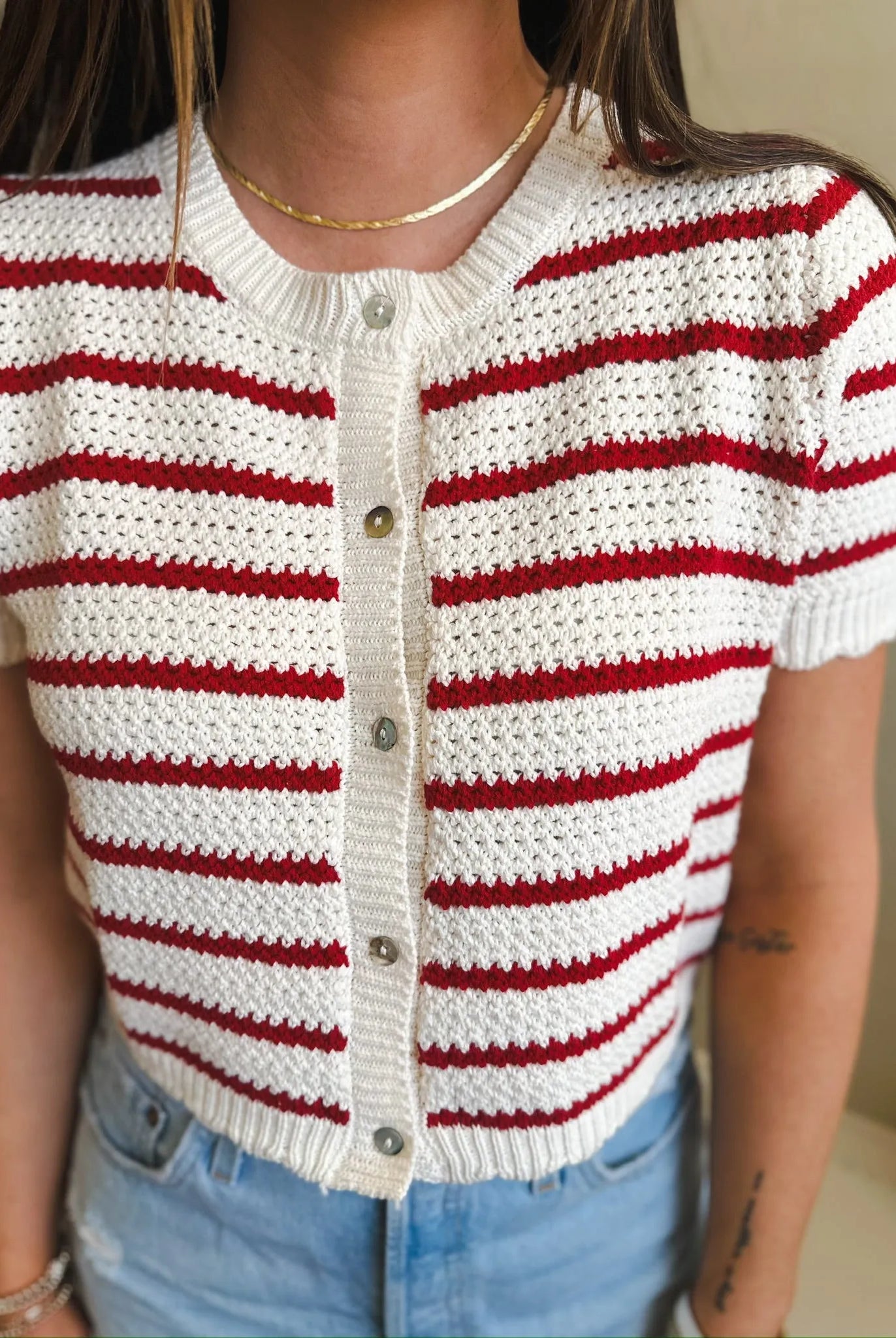 Short sleeve cream and red striped button-down knit cardigan sweater with a crochet-like texture.