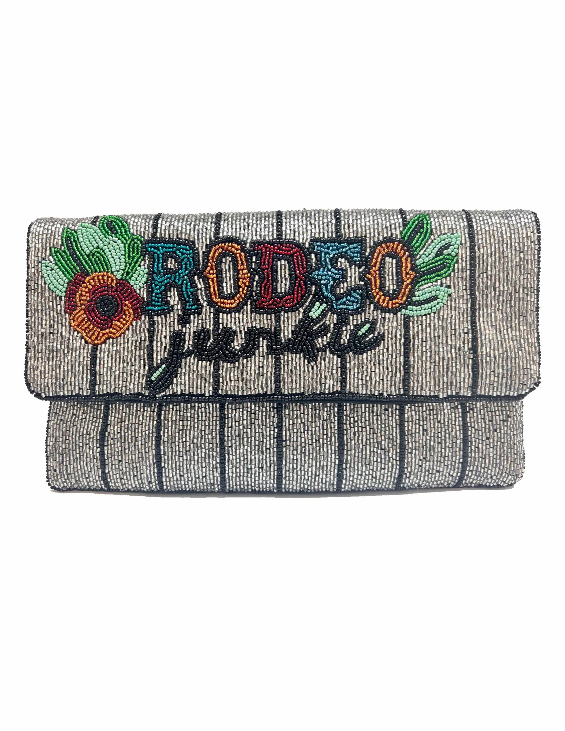 Silver beaded clutch with vertical black stripes. Features colorful beaded text "RODEO" and