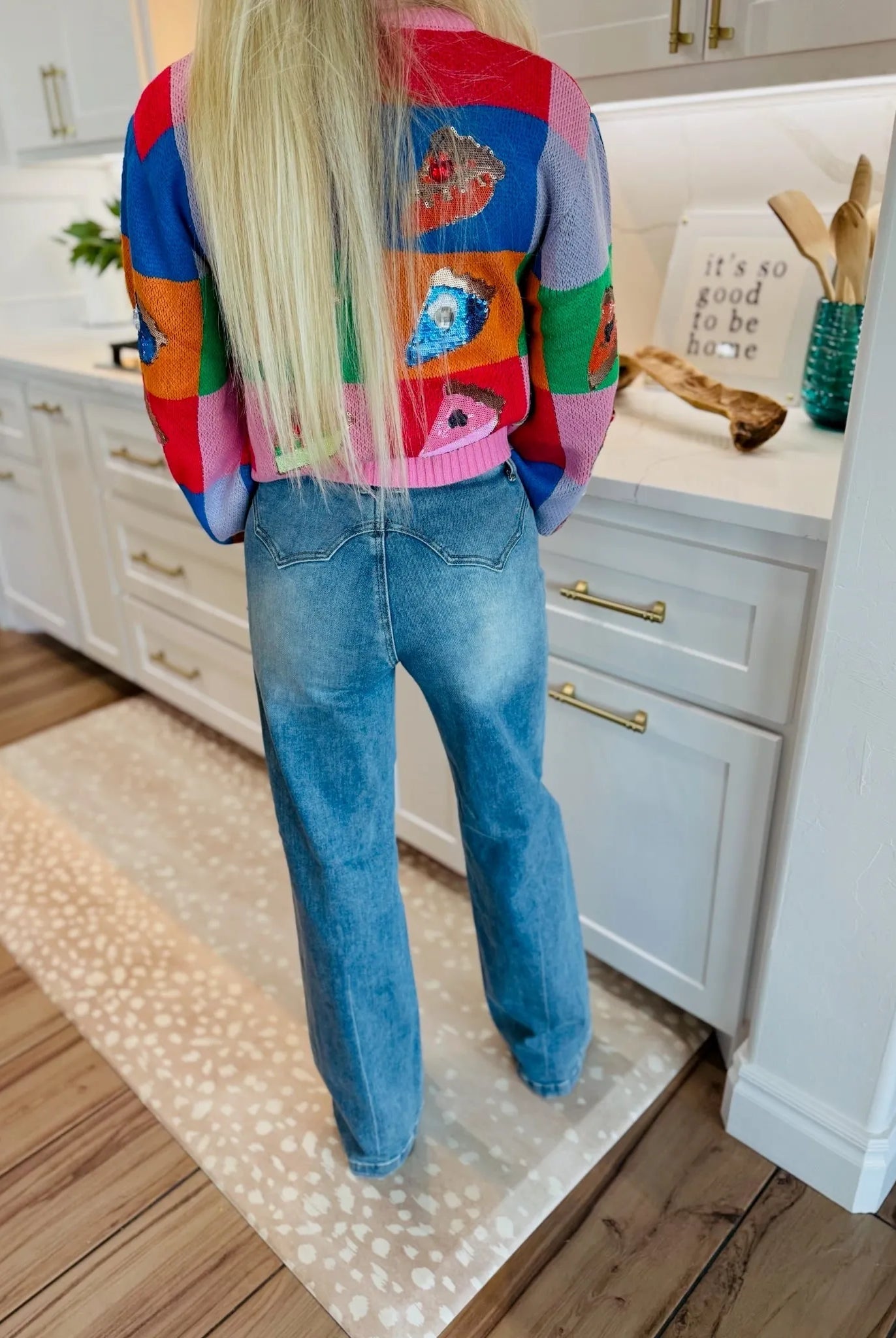 Back view of woman wearing SAIGE High-Rise Double-Pocket Wide-Leg Jeans in blue denim, featuring a Western-style yoke.